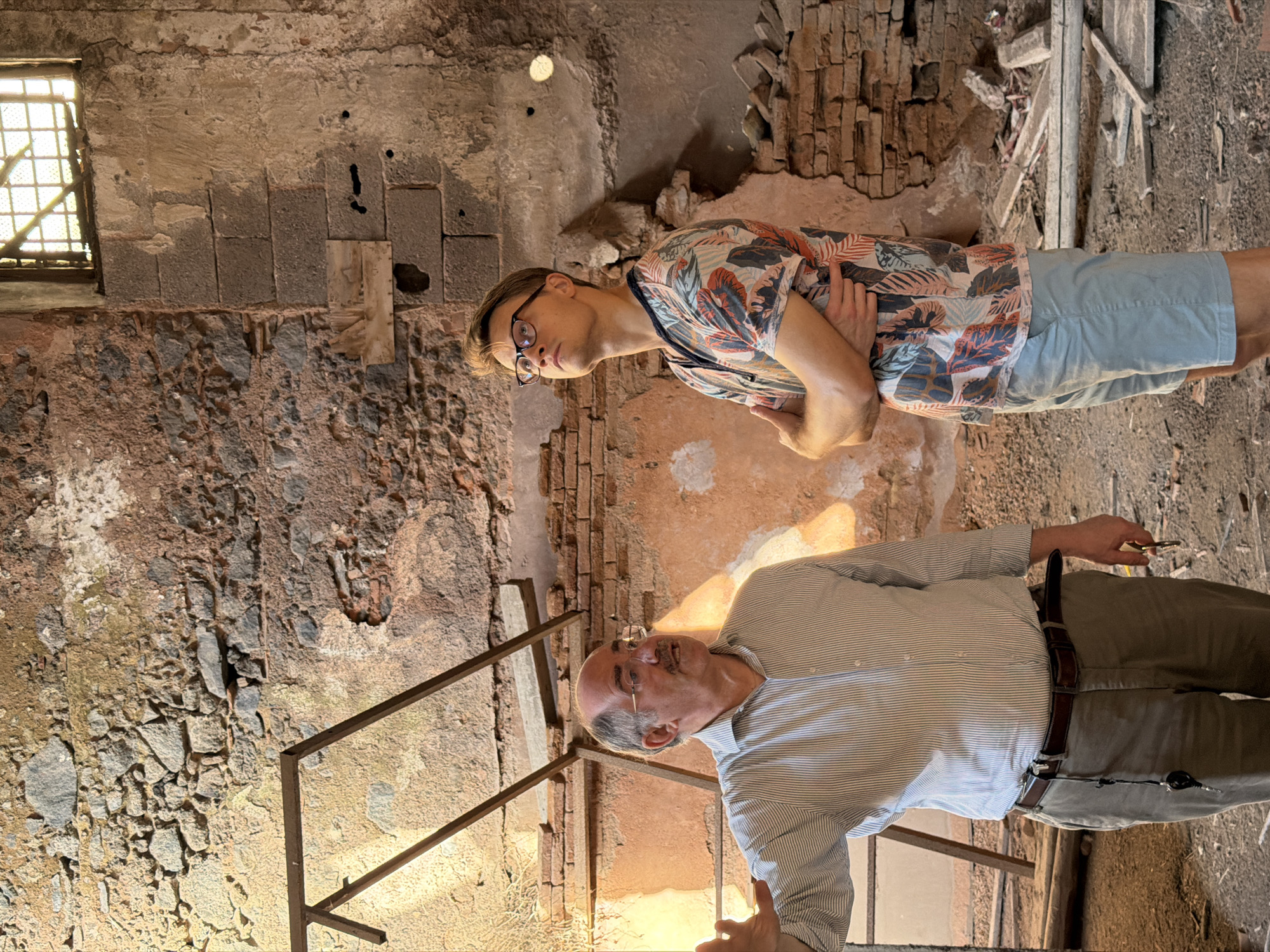 Two men explore abandoned, crumbling building in Catania