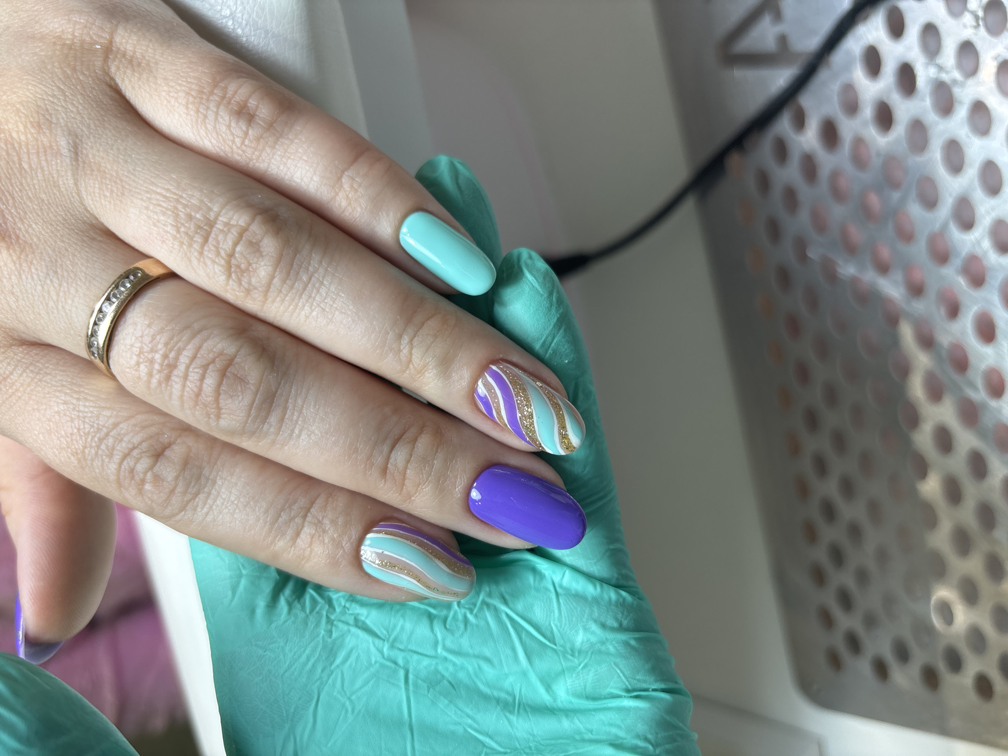 Manicured hand photographed with nitrile glove in rural Russia