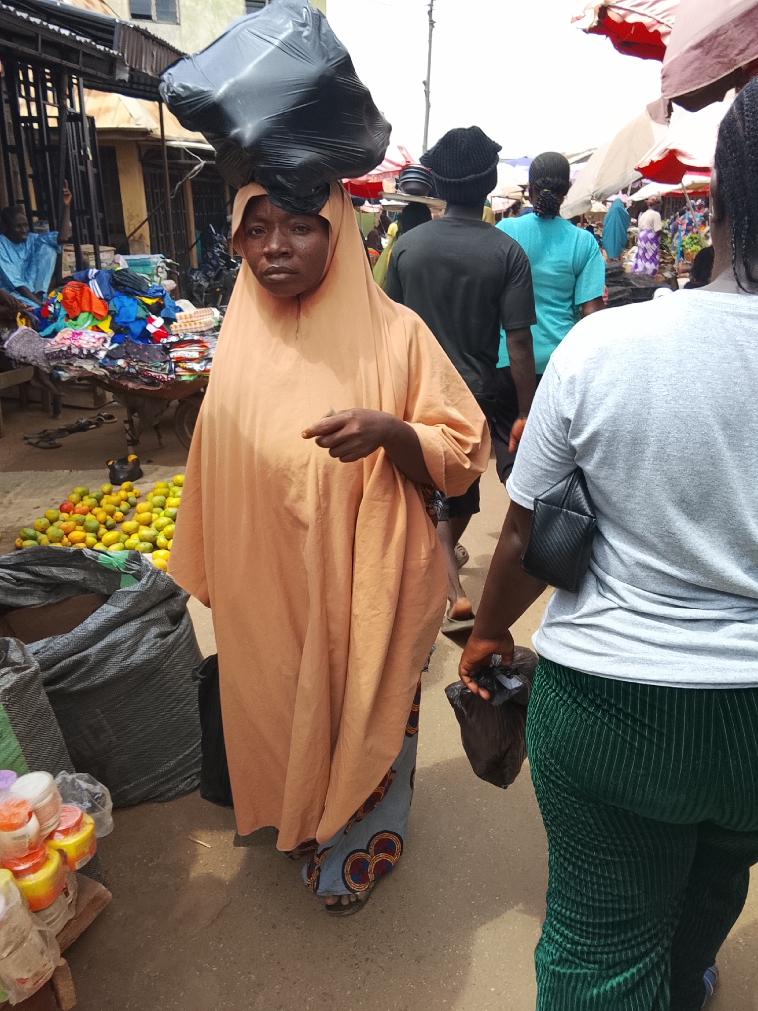 Market vendors conduct routine business at outdoor marketplace