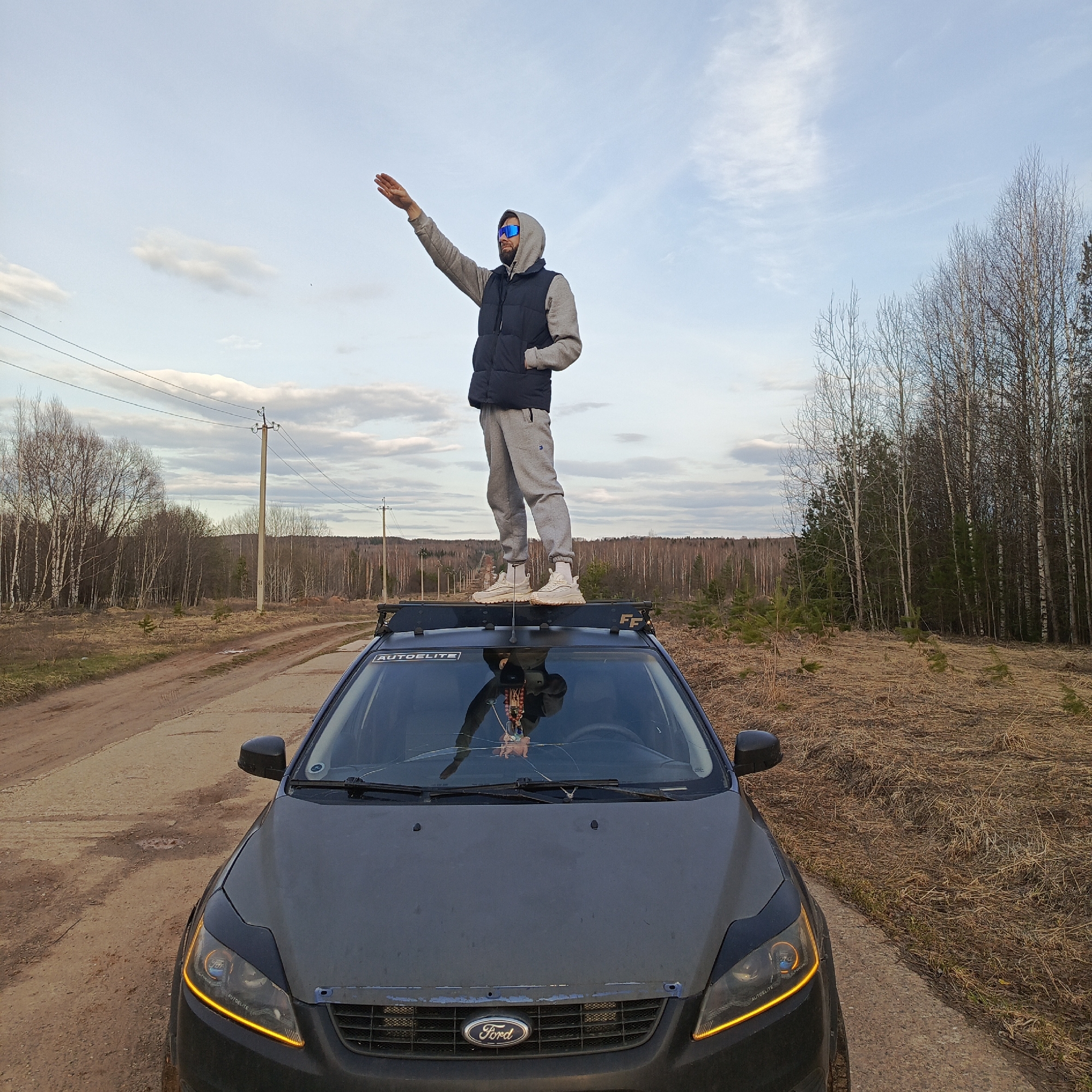 Man performs car stunts on dirt road in Марковский