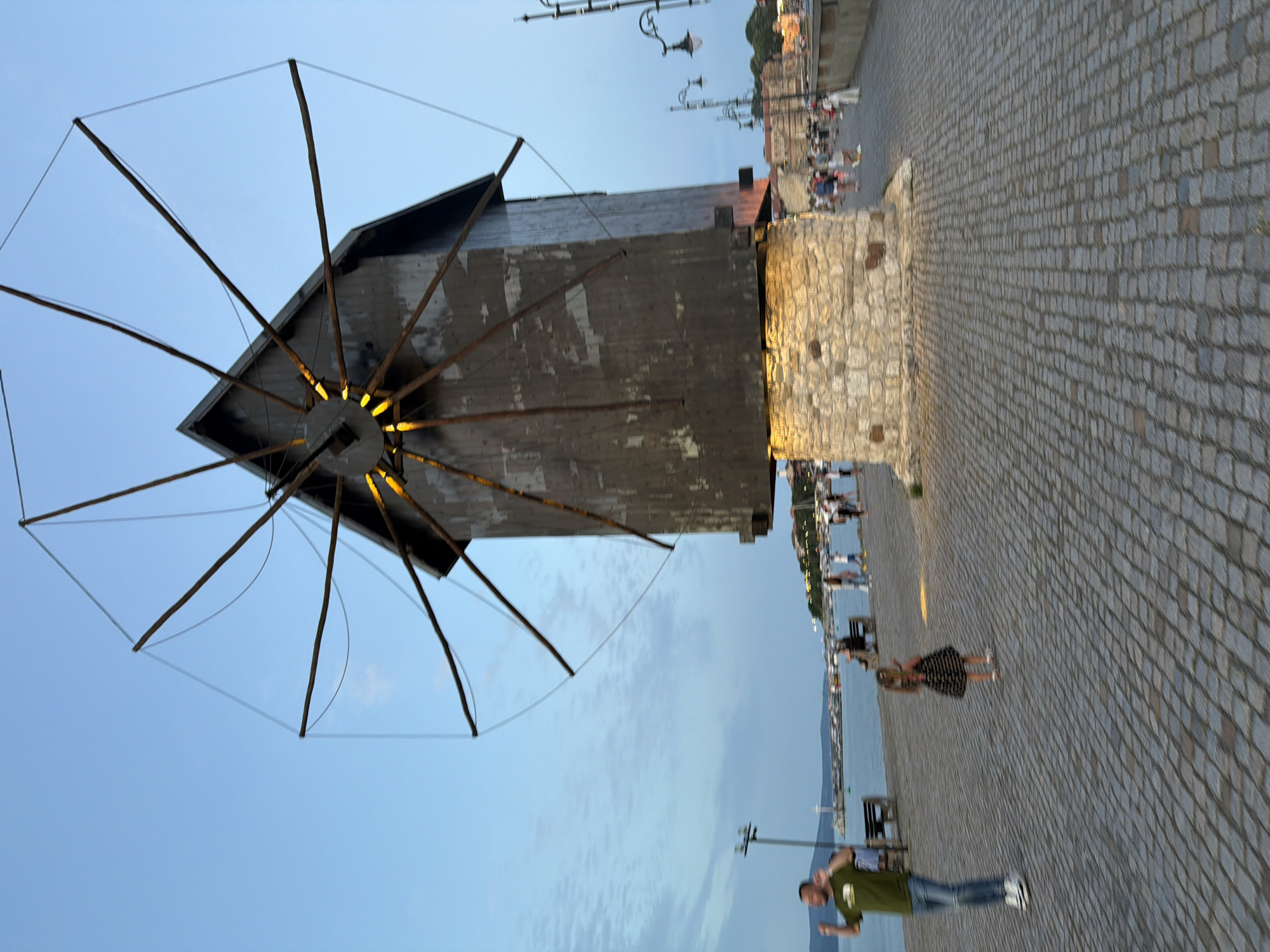 Nesebar's waterfront windmill at golden hour