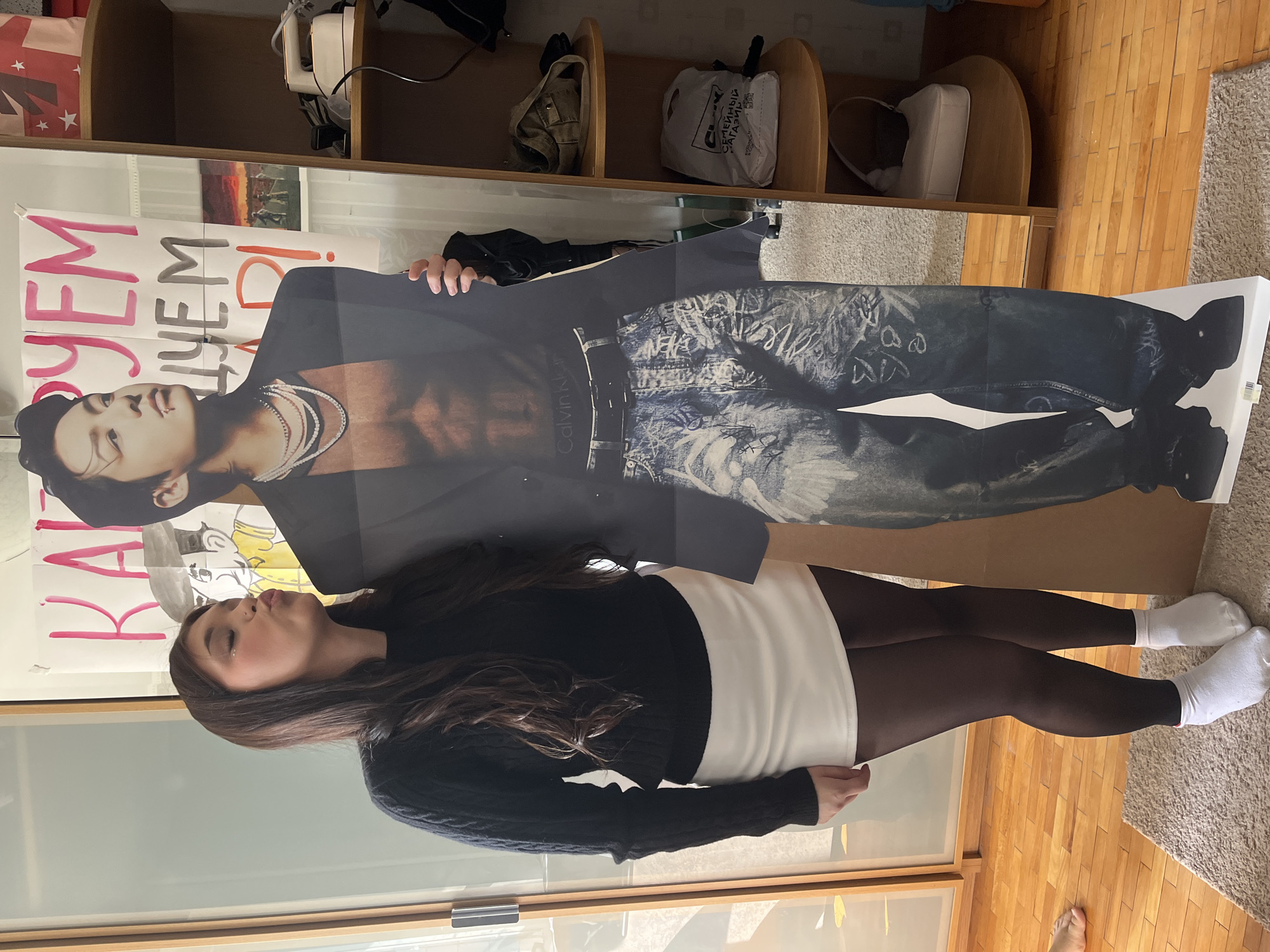 Woman plays with cardboard cutout in Saint Petersburg indoor venue