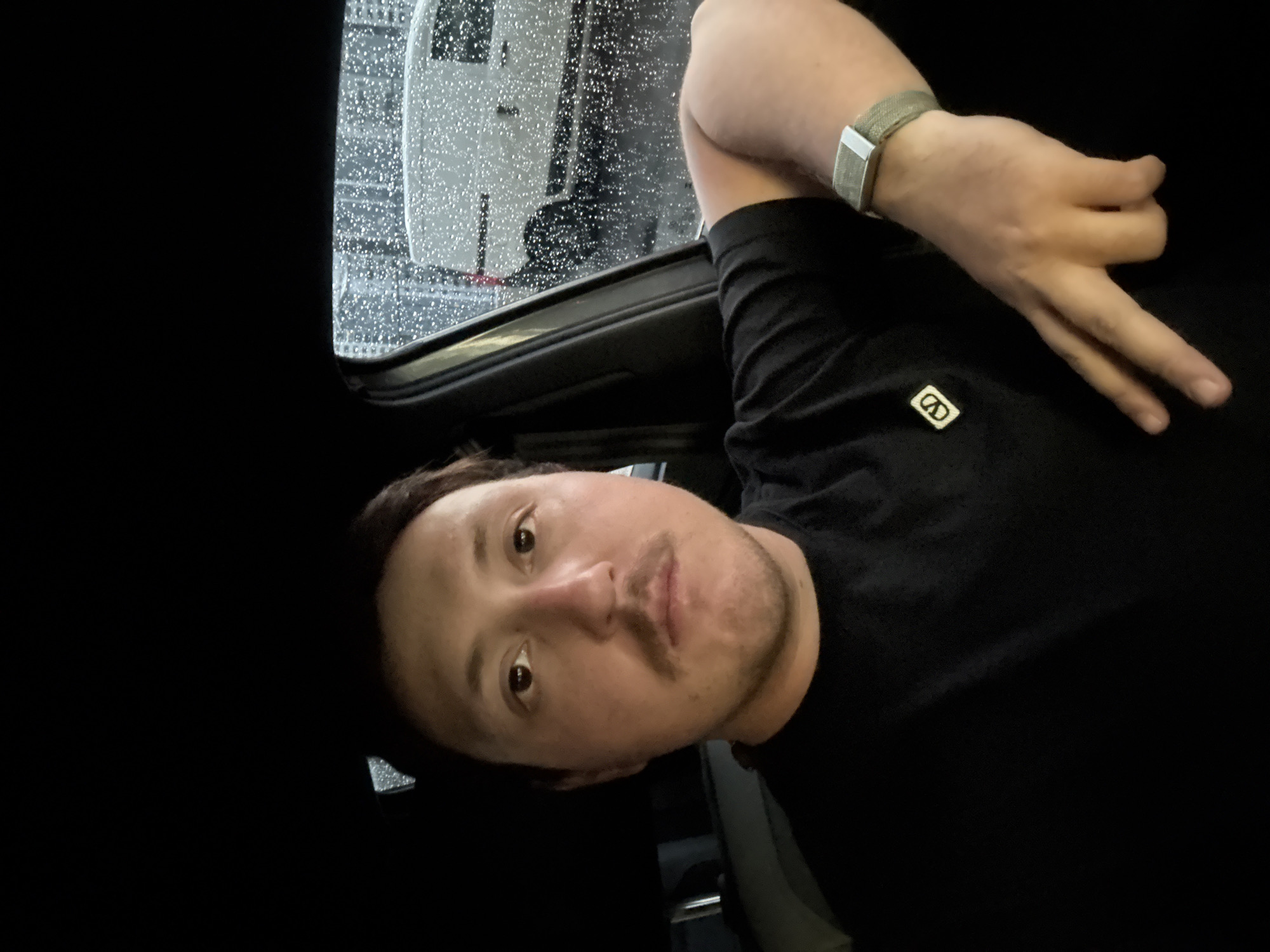 Man sits in vehicle during rain in Huixquilucan