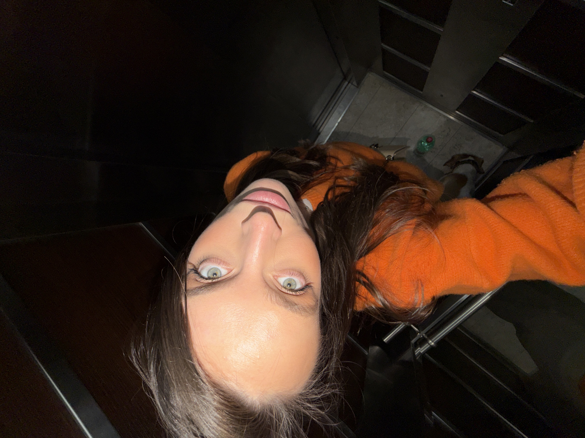 Woman takes selfies in elevator, walks through Budva parking garage