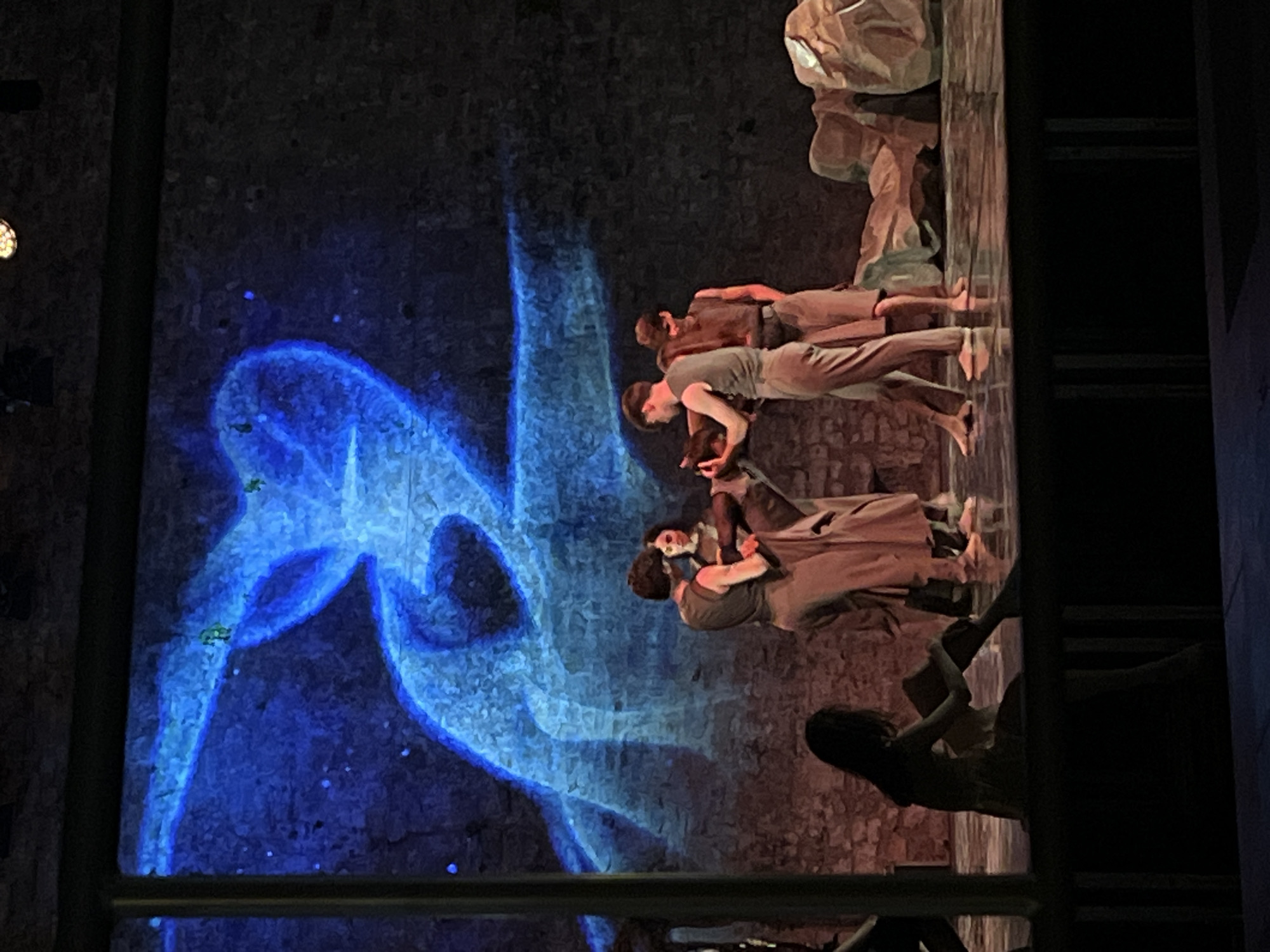 Outdoor dance performance under blue projections in Budva, Montenegro