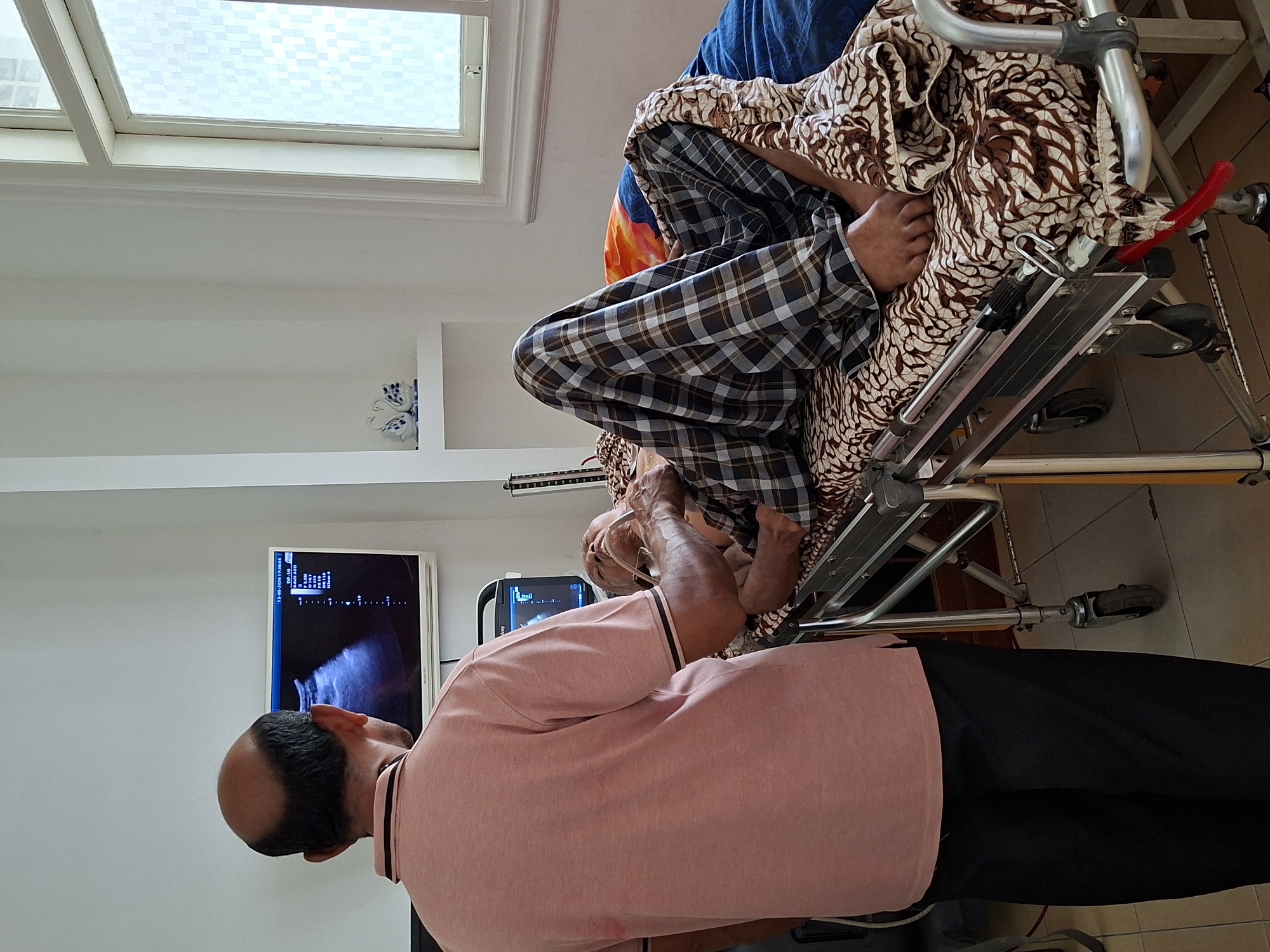 Elderly patient undergoes ultrasound at Indonesian health clinic