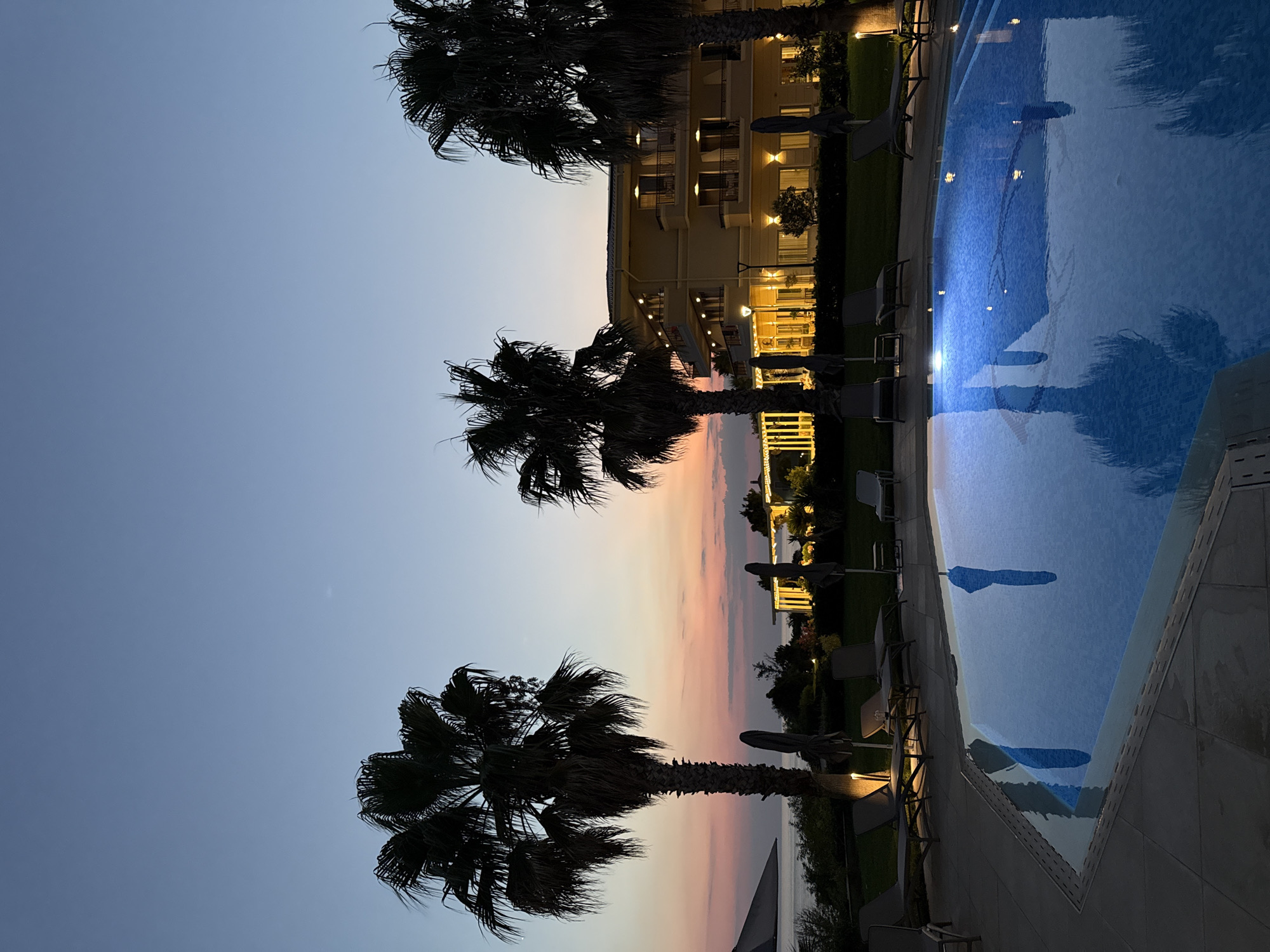 Twilight poolside at a resort in Platanitis, Greece