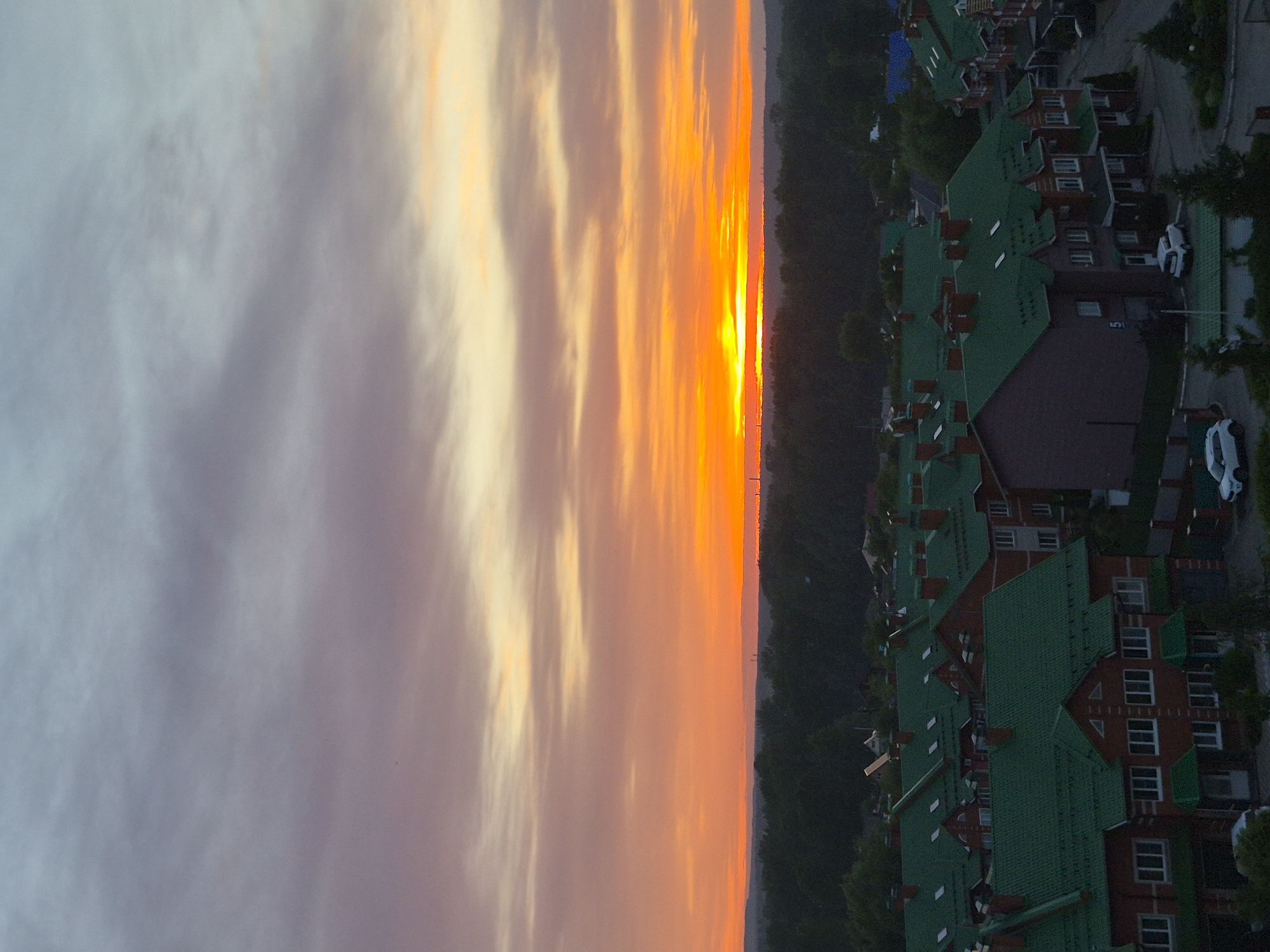 Witness documents vibrant sunset over unknown city residential area