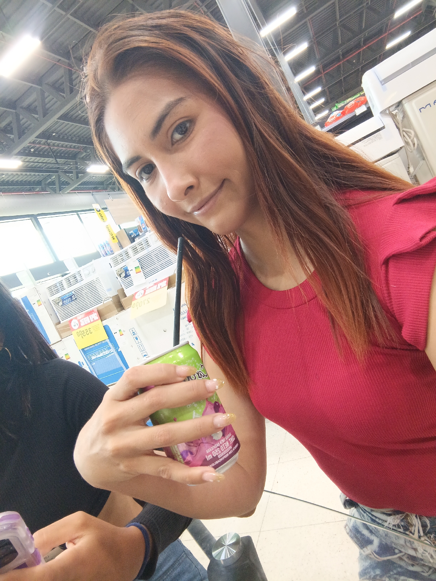Two women share drinks, selfies at Juan Griego food court