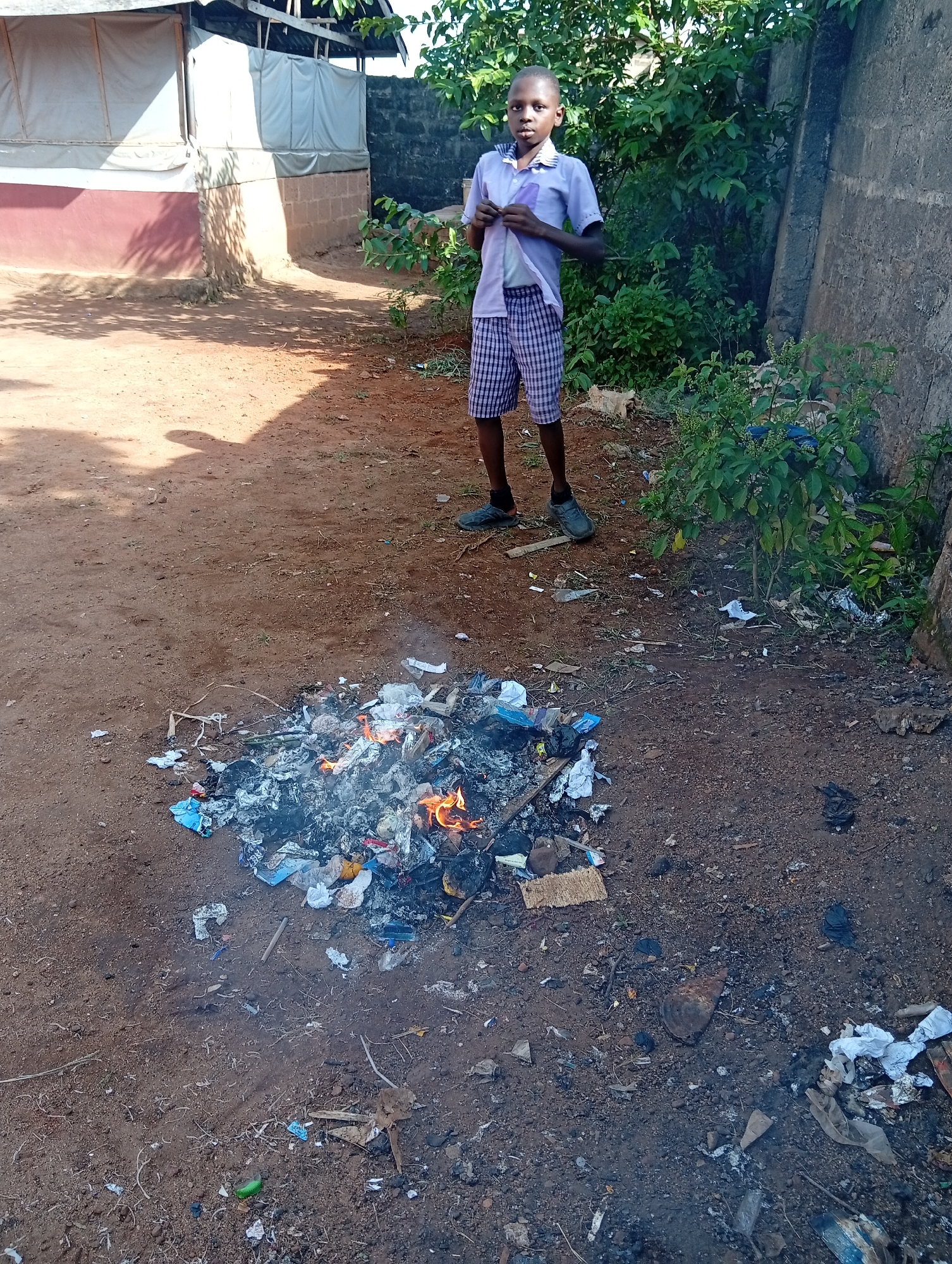 Person observed near burning waste pile in open area