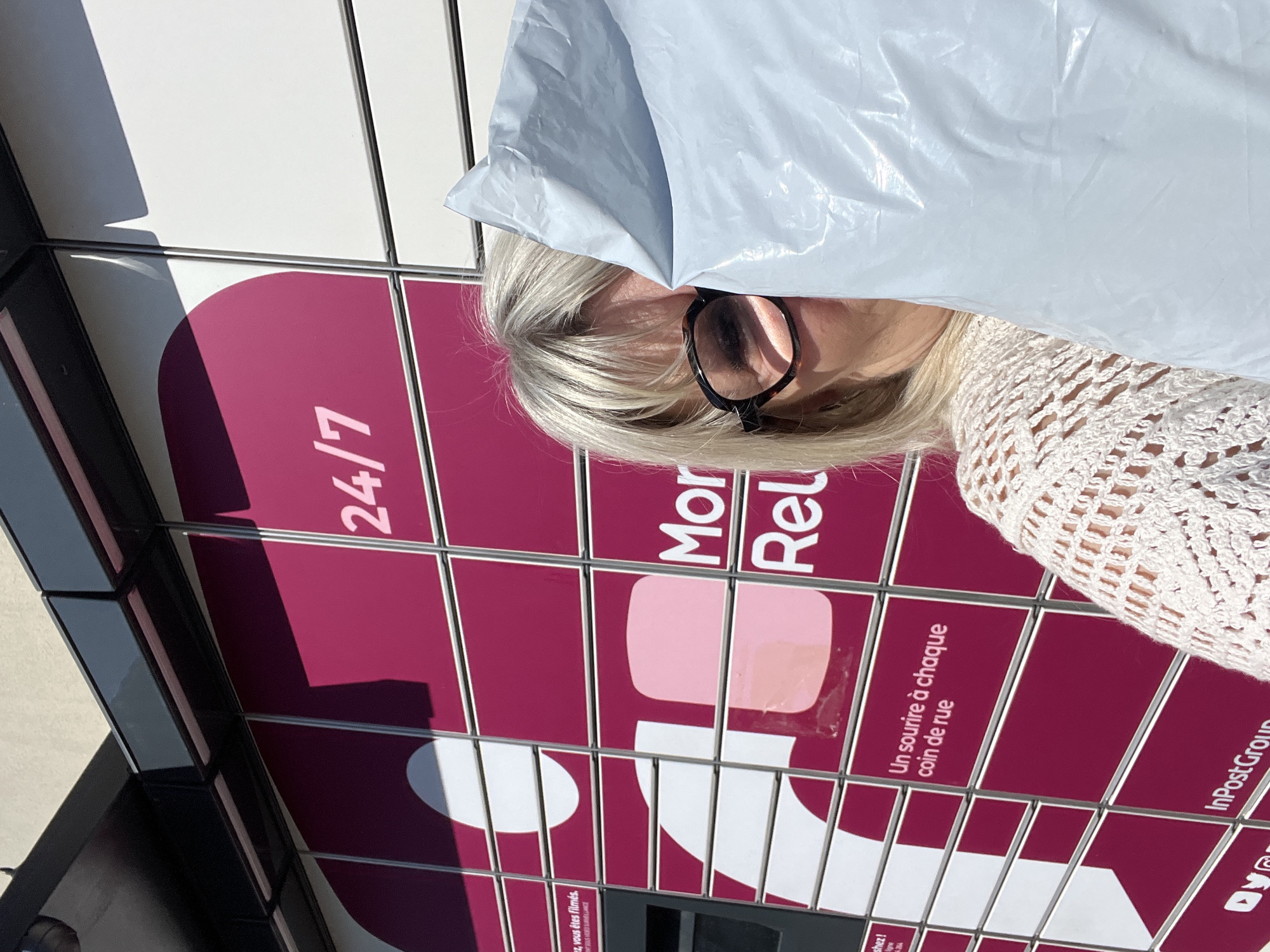 Woman holds plastic bag over head in Saint-Galmier
