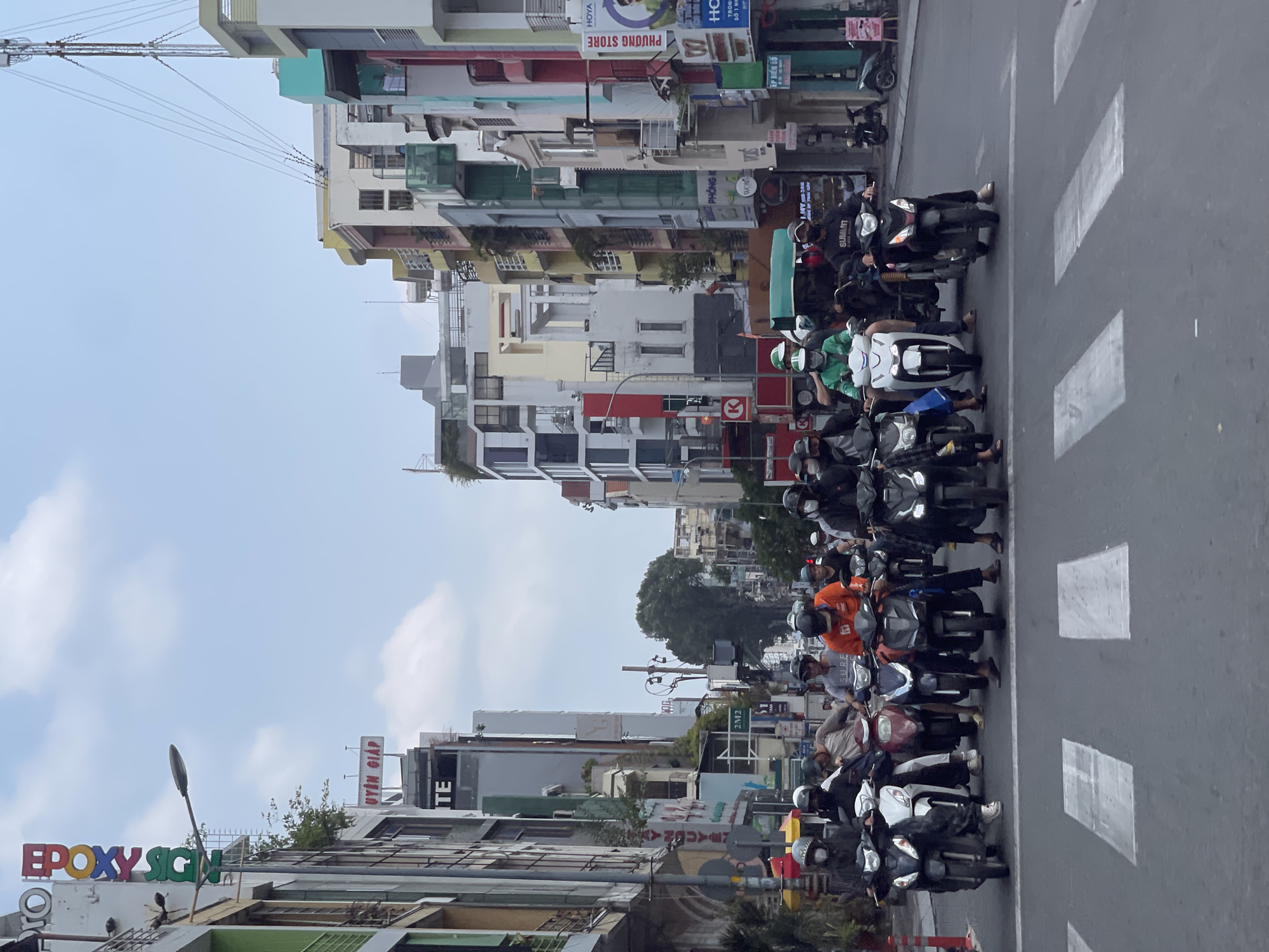 Motorbikes queue at crosswalk in Thủ Đức, Vietnam
