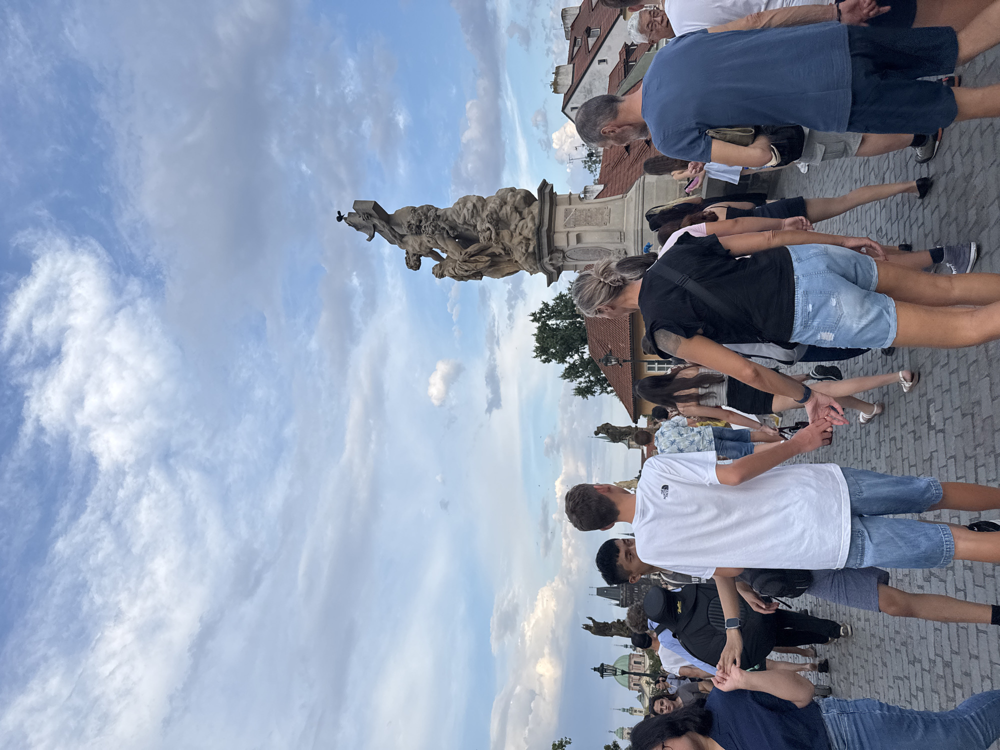 Charles Bridge crowds under dramatic summer skies, Prague