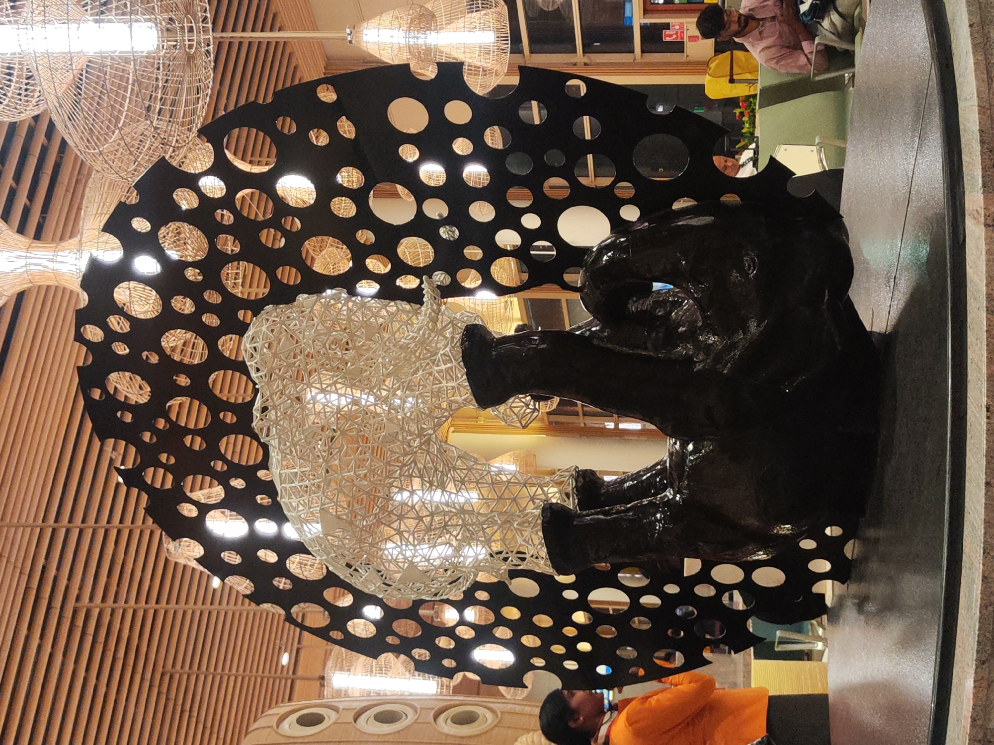 Black circular-cutout artwork photographed in Gangamuthanahalli, India