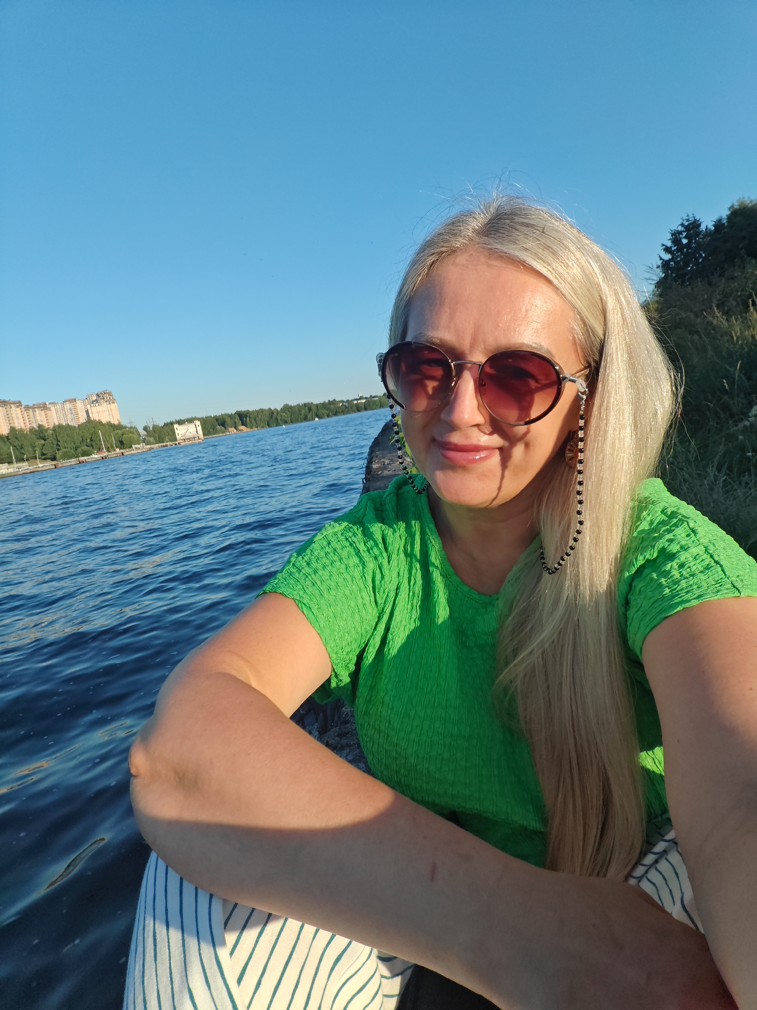 Afternoon on a Russian urban river, boats and embankment views