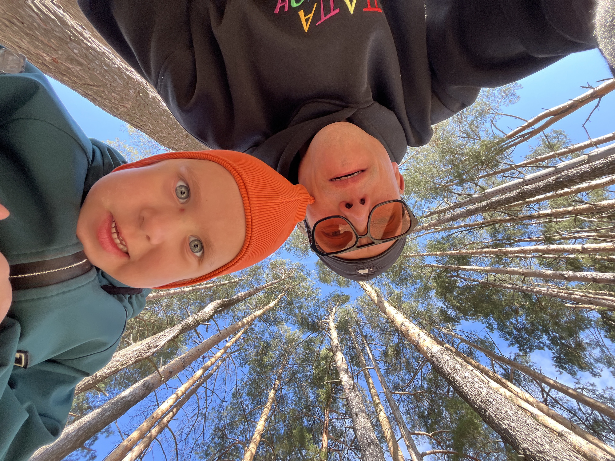 Child in stroller gestures during forest walk near Chaikovsky