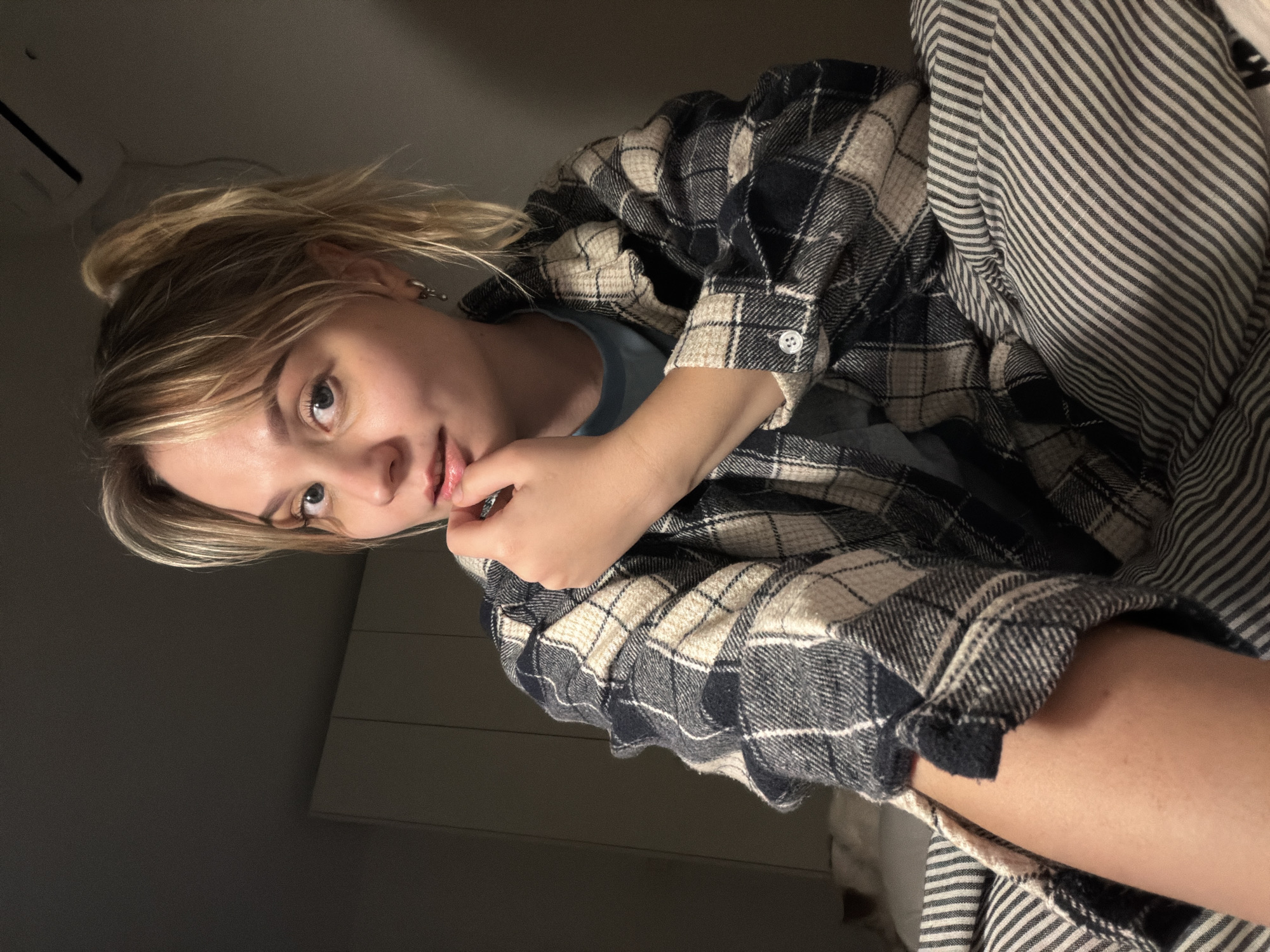 Young blonde woman observed indoors in Tel-Aviv bedroom