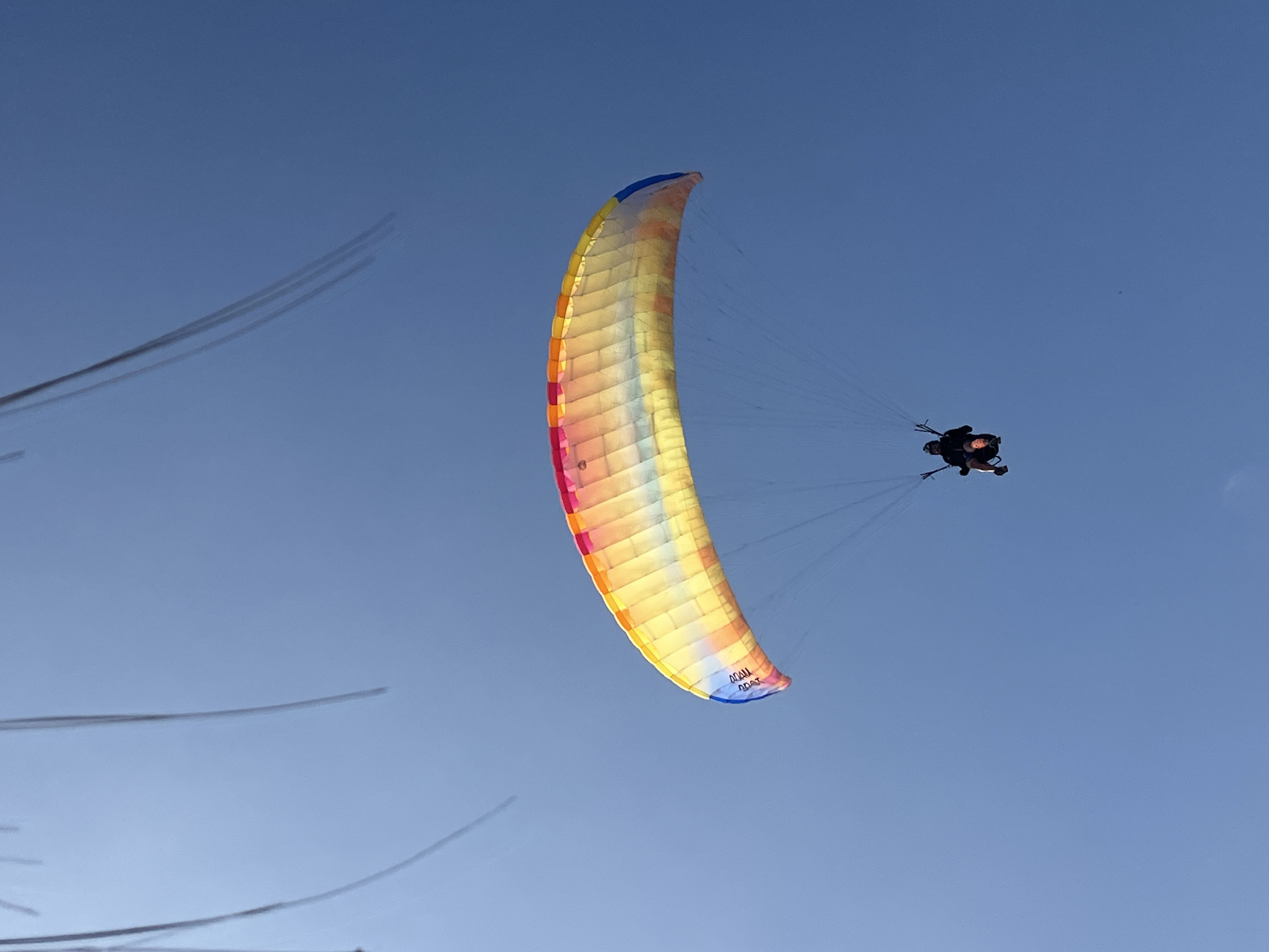 Paragliding event on Arica's beach, multiple pilots and ground crew