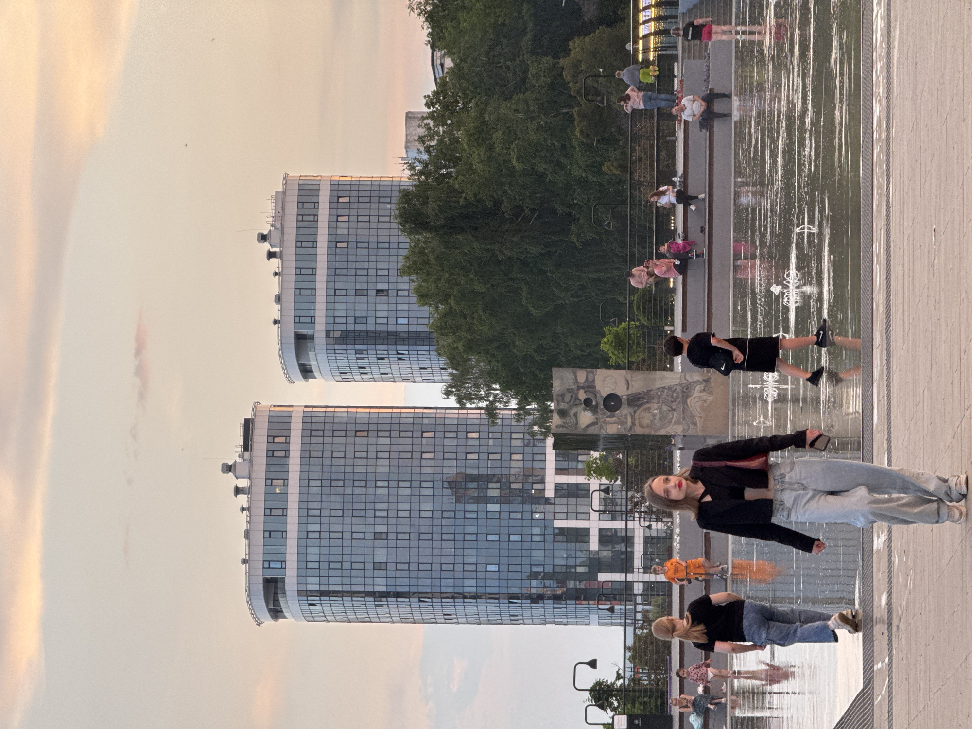 Evening fountain plaza scene with children playing in Izhevsk