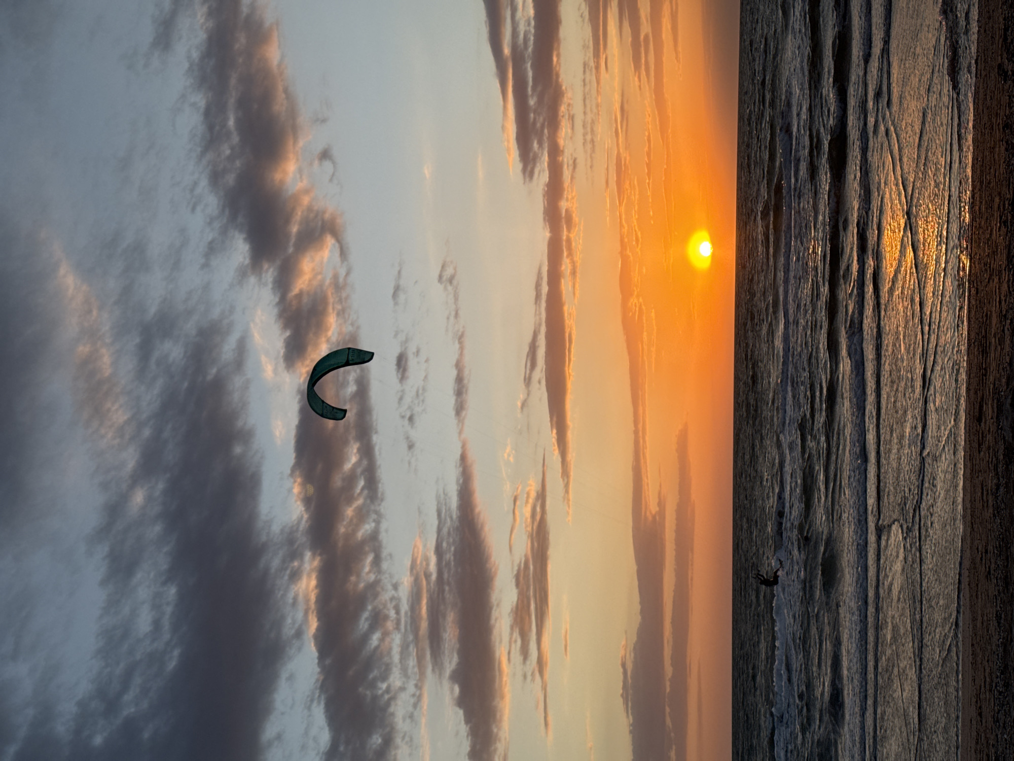 Kite surfers ride sunset waters near Shchelkino, Ukraine
