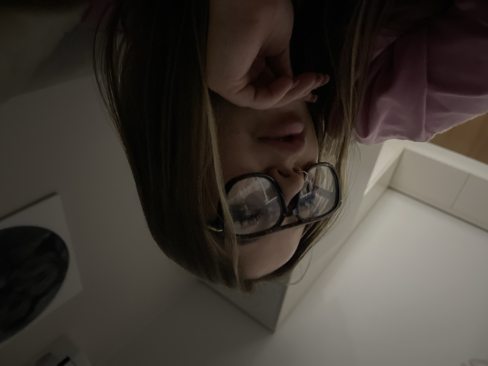 Woman photographed upside-down with hand covering face in Krasnodar