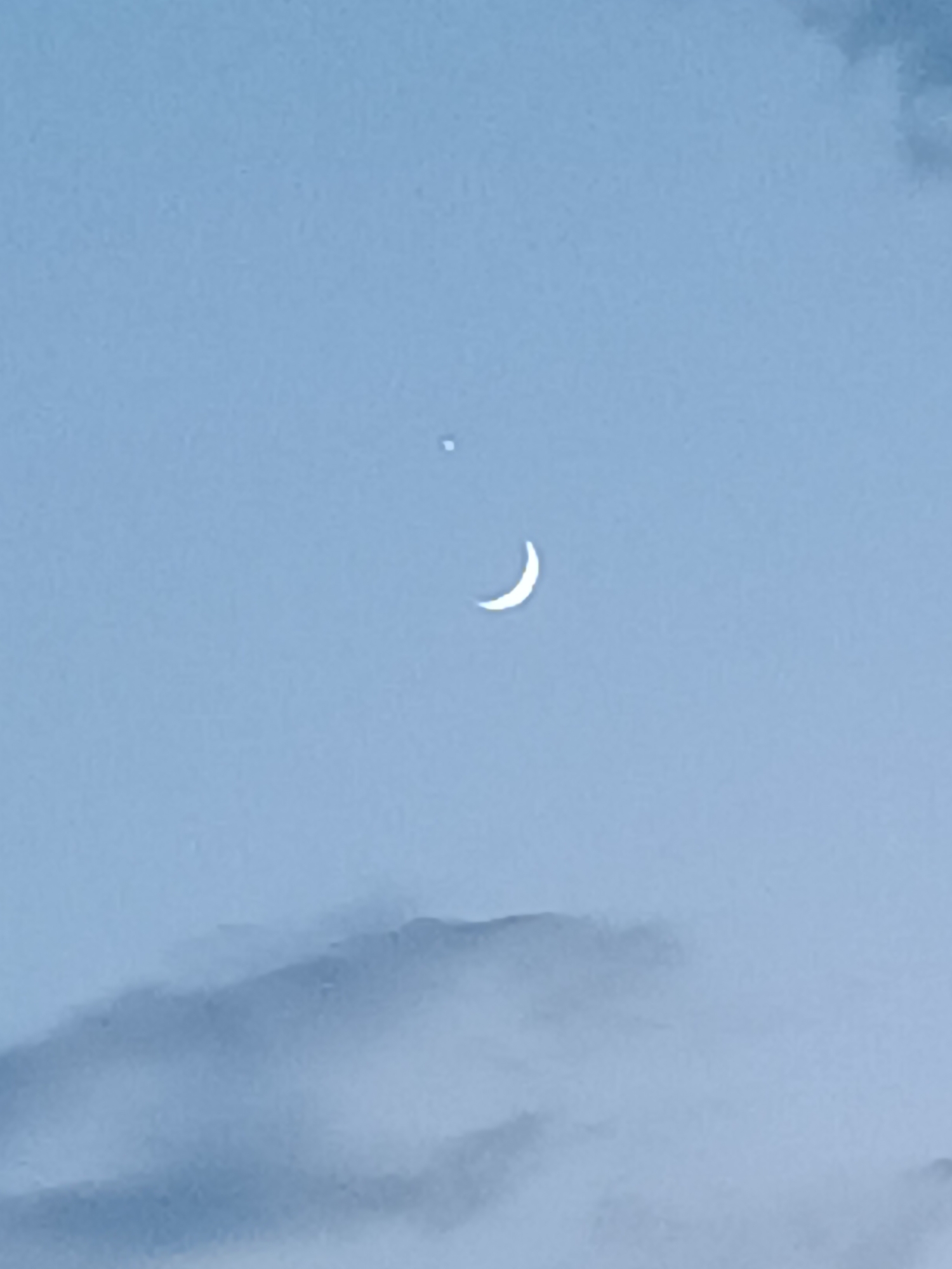 Crescent moon and planet at twilight over Vitoria-Gasteiz