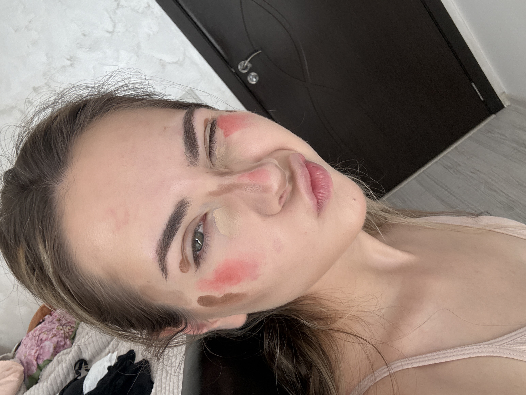 Woman applies makeup during beauty routine in Blagoevgrad residence