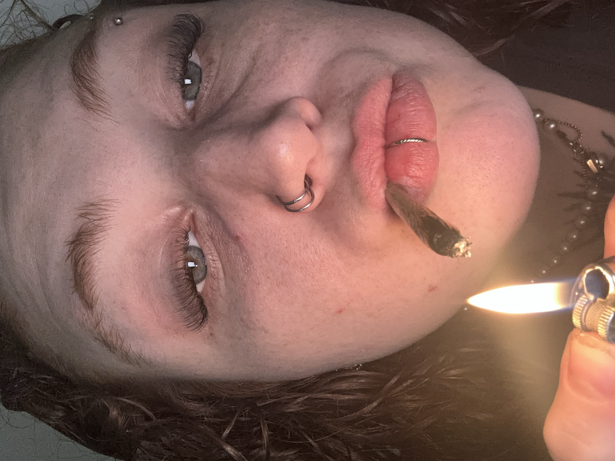 Person with piercings smokes cigarette in Buenos Aires