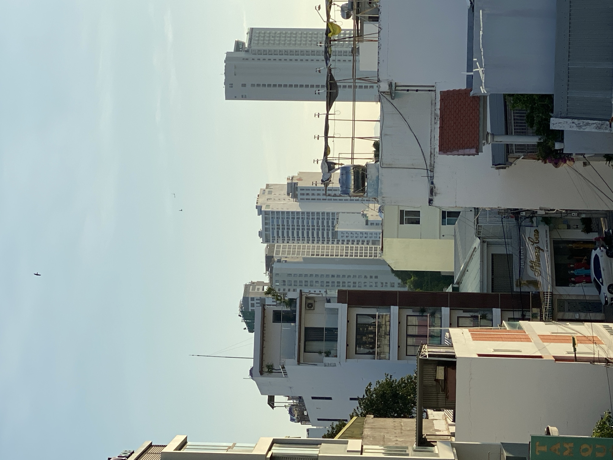 Street-level urban scenes with mountains, scooters, and overhead wires