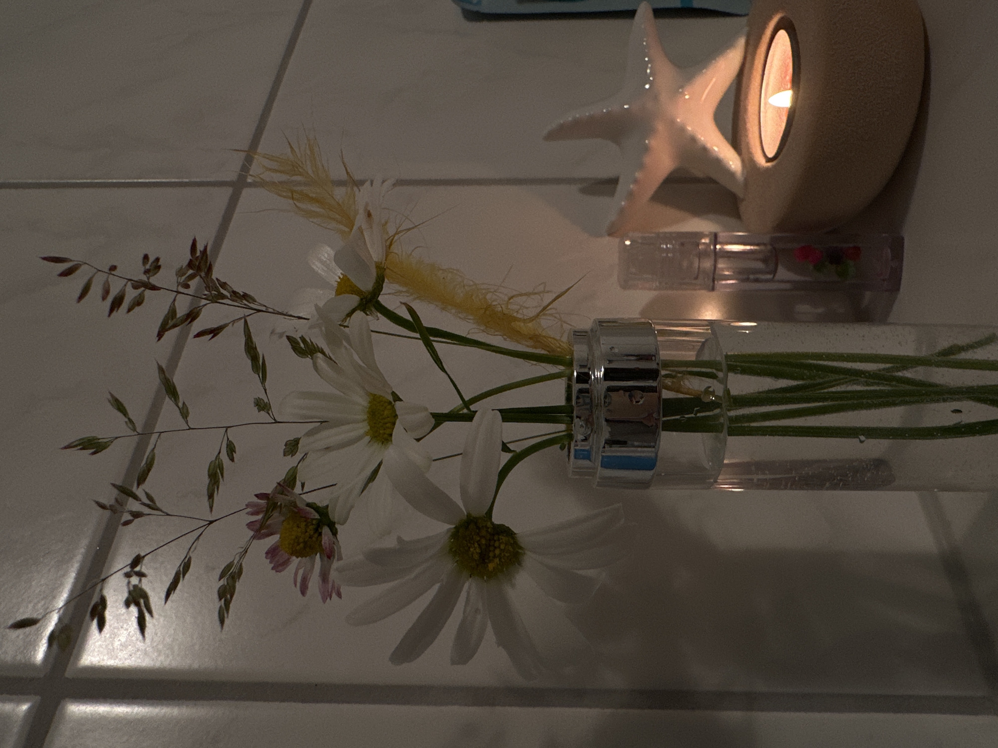 Person documents bathroom wildflower arrangements in Krefeld, Germany