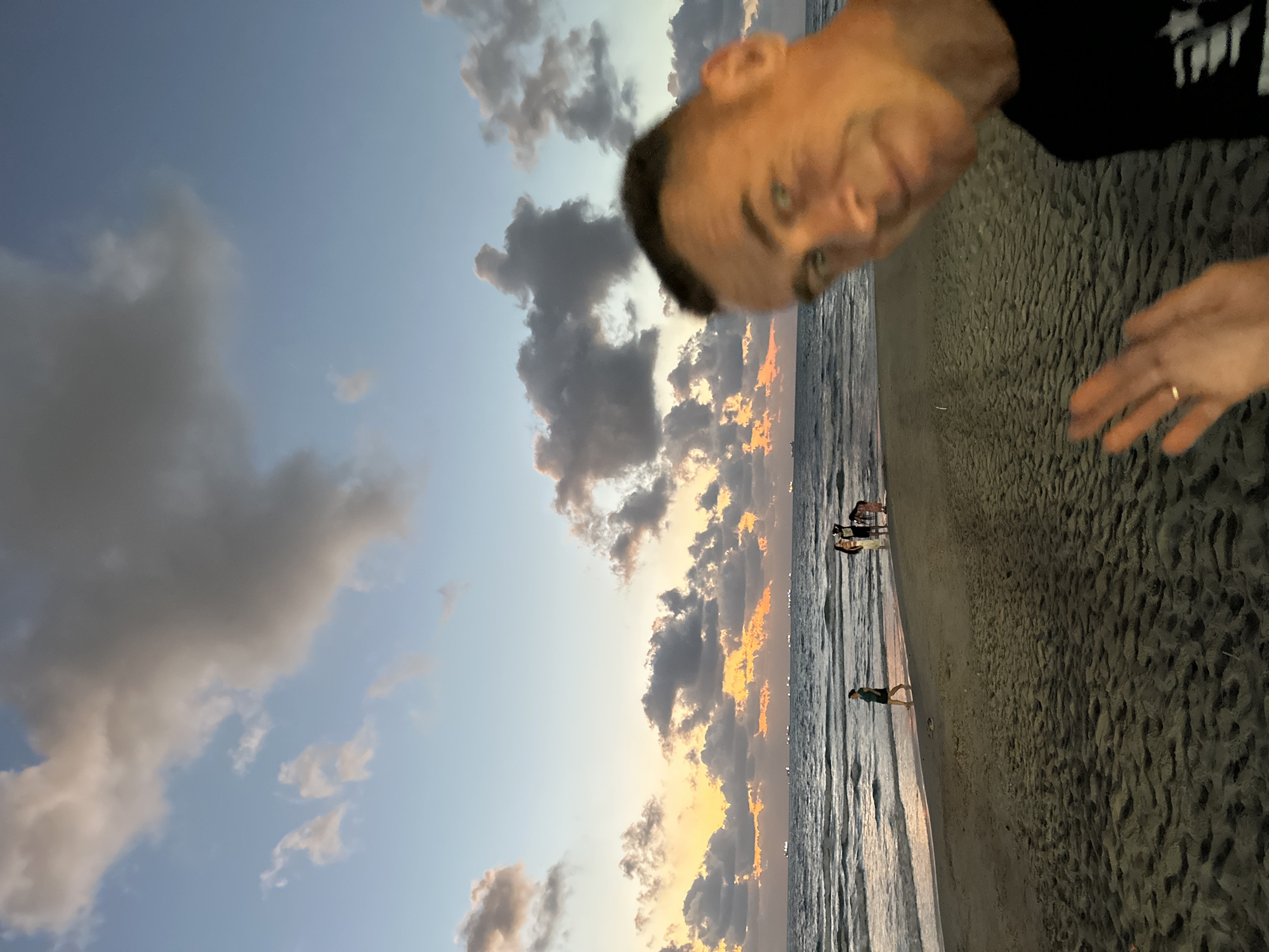 Kiryat Yam beachfront at dusk, ships and sunset clouds
