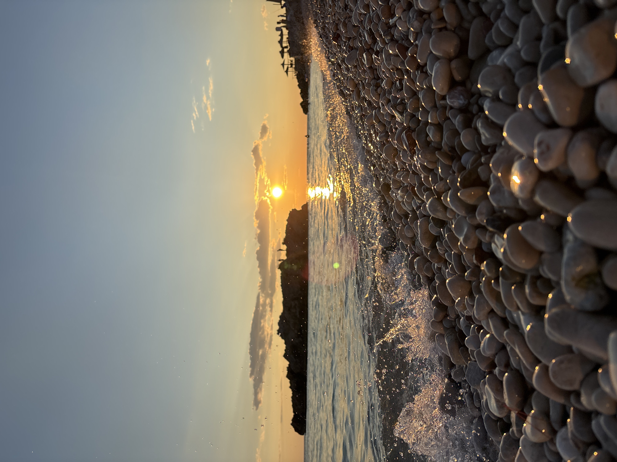Sunset glow over Dobra Voda's pebbled Adriatic shore