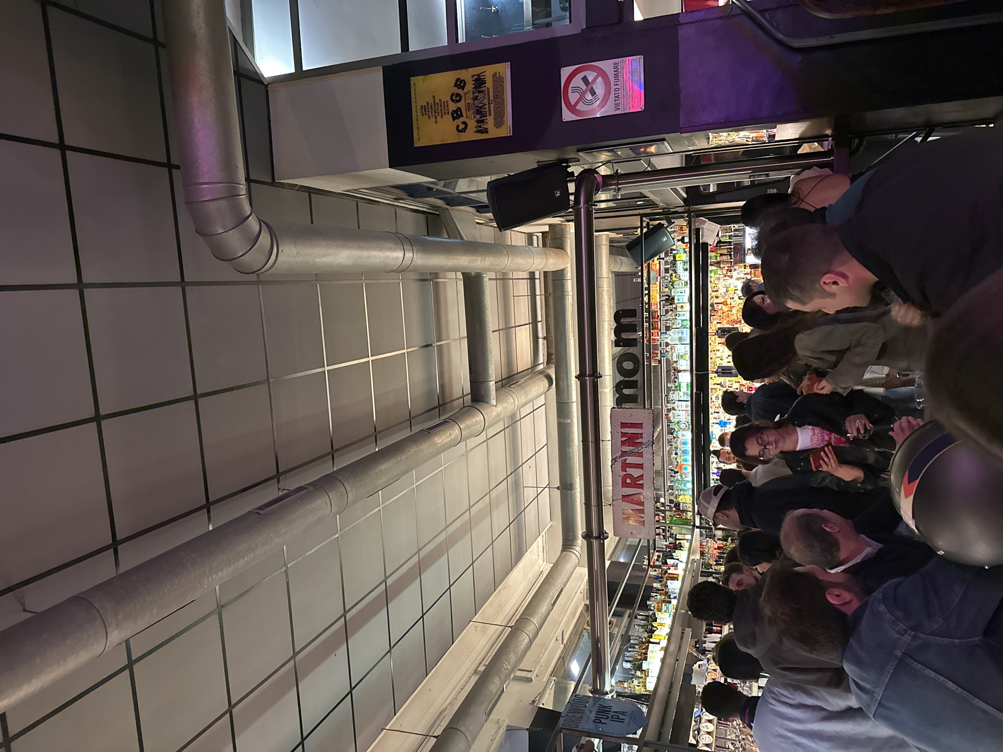 Crowded Milan bar features King Crimson artwork, packed patrons