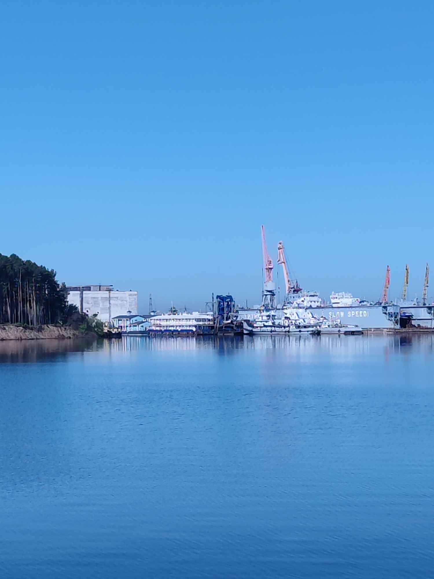 Harbor scene with ships and industrial structures documented