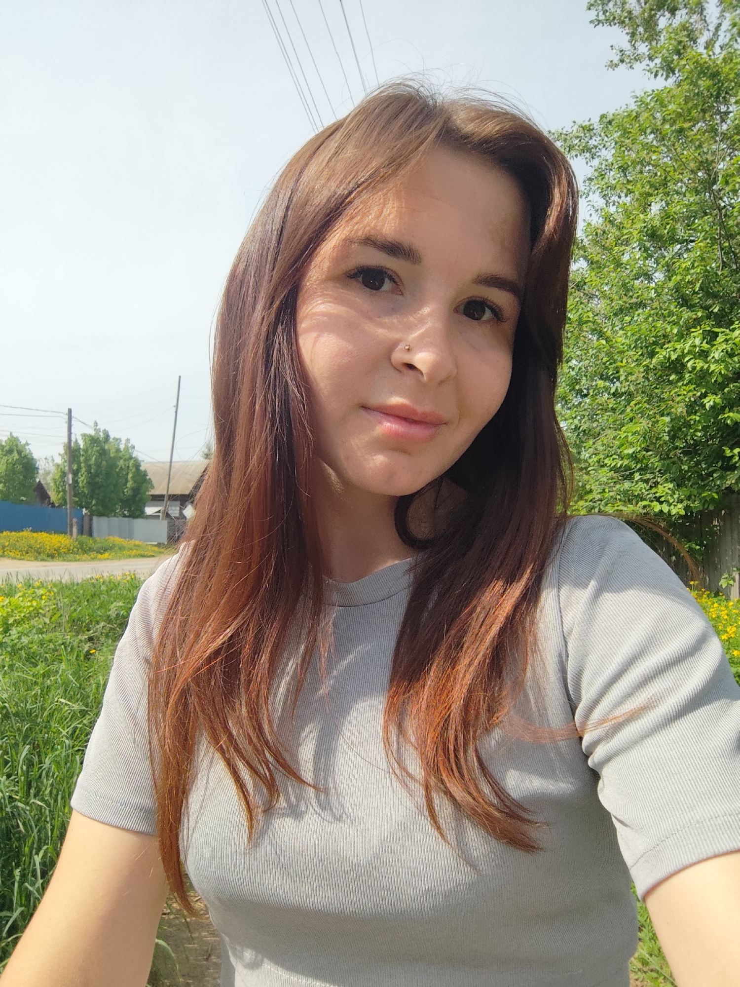Woman takes selfie among wildflowers in rural Russia