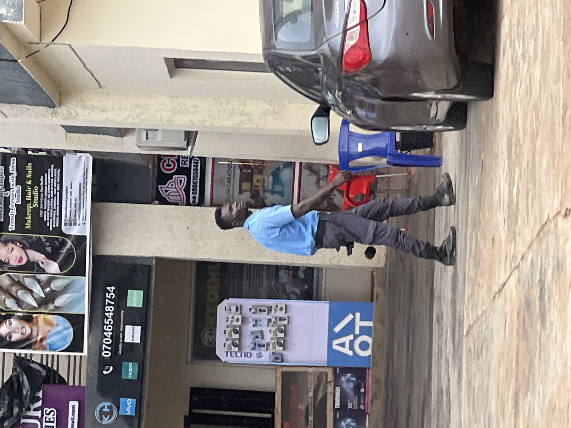 Street life and commerce along a busy Okpanam, Nigeria thoroughfare