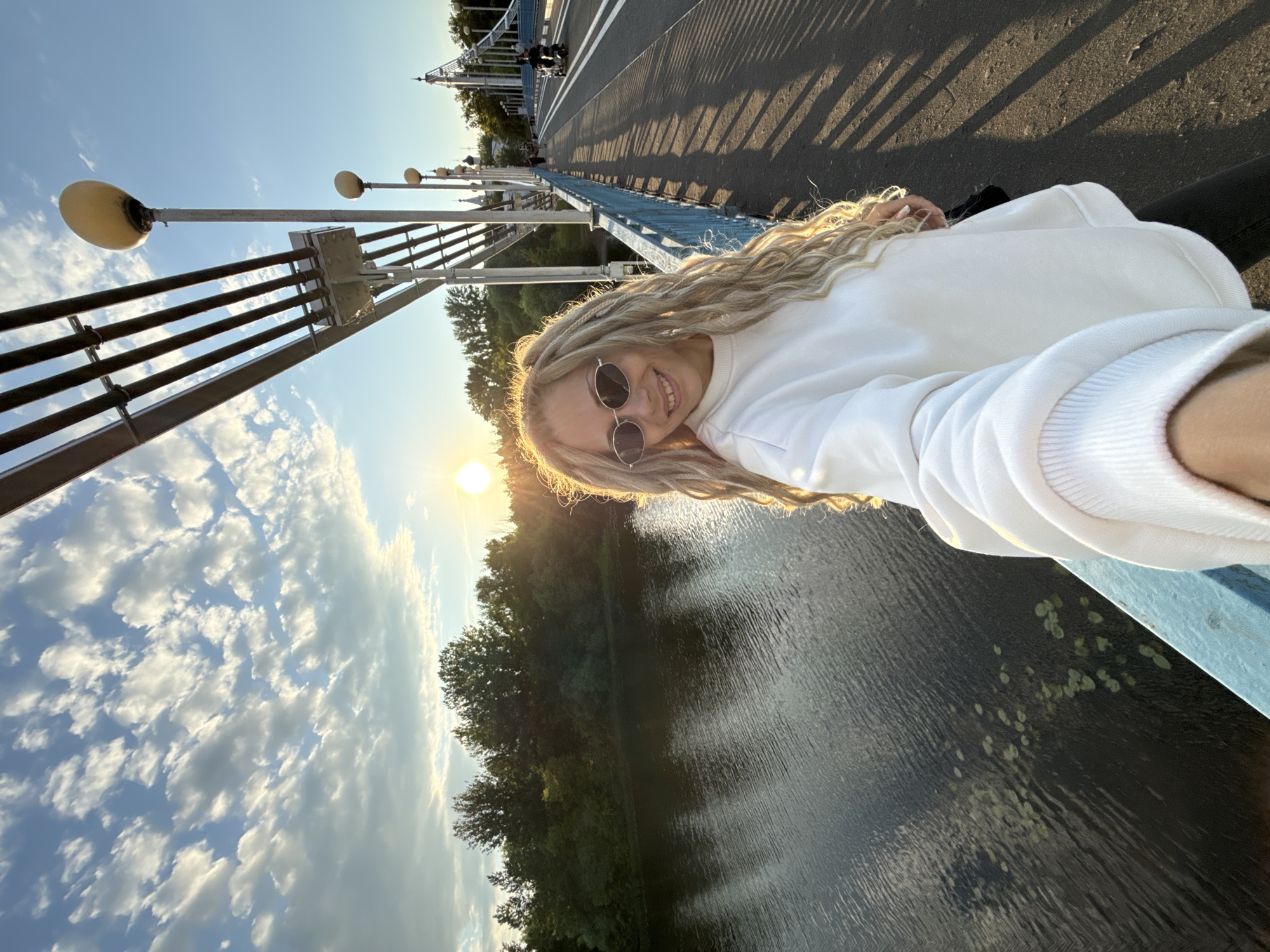 Woman takes sunny selfie on bridge in Шебунино, Russia