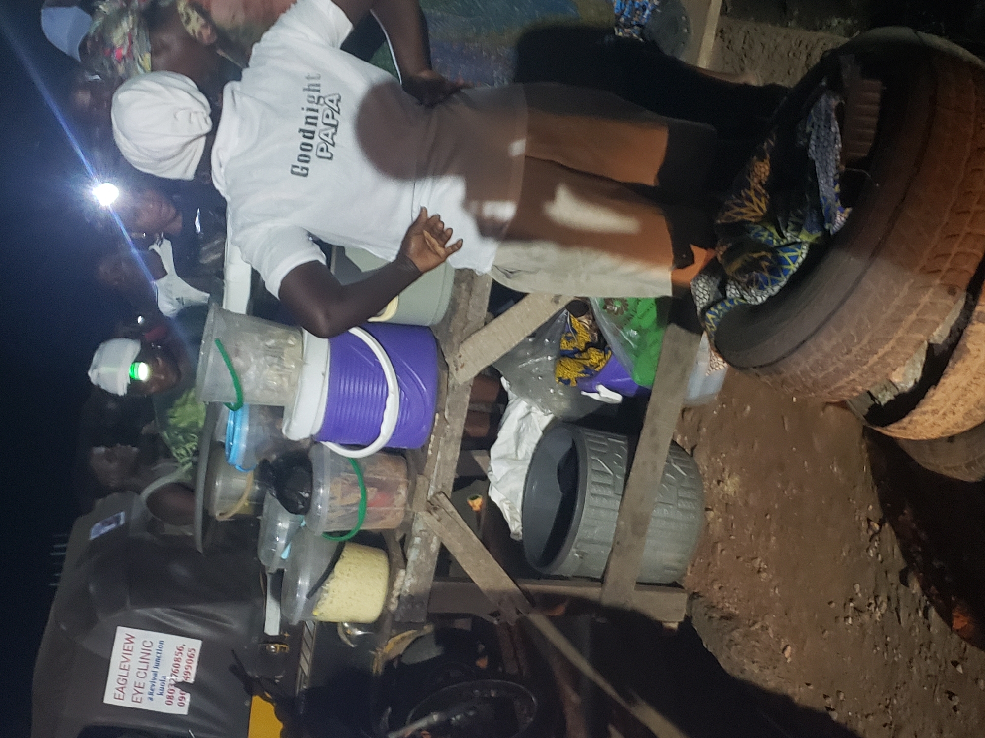 Night market food vendors serve customers in Ibadan