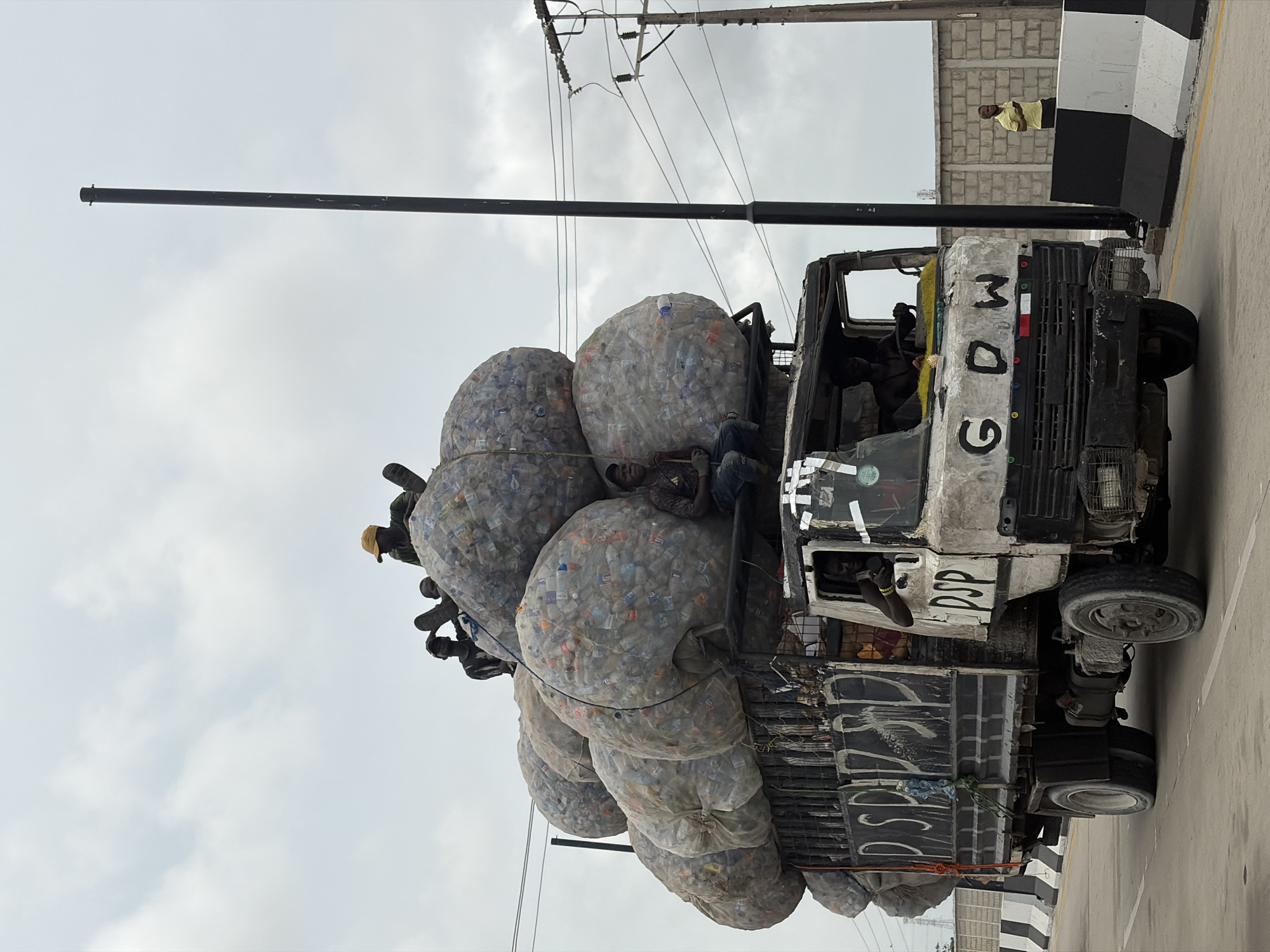 Truck hauling plastic bottles, horseback rider spotted in Nigeria