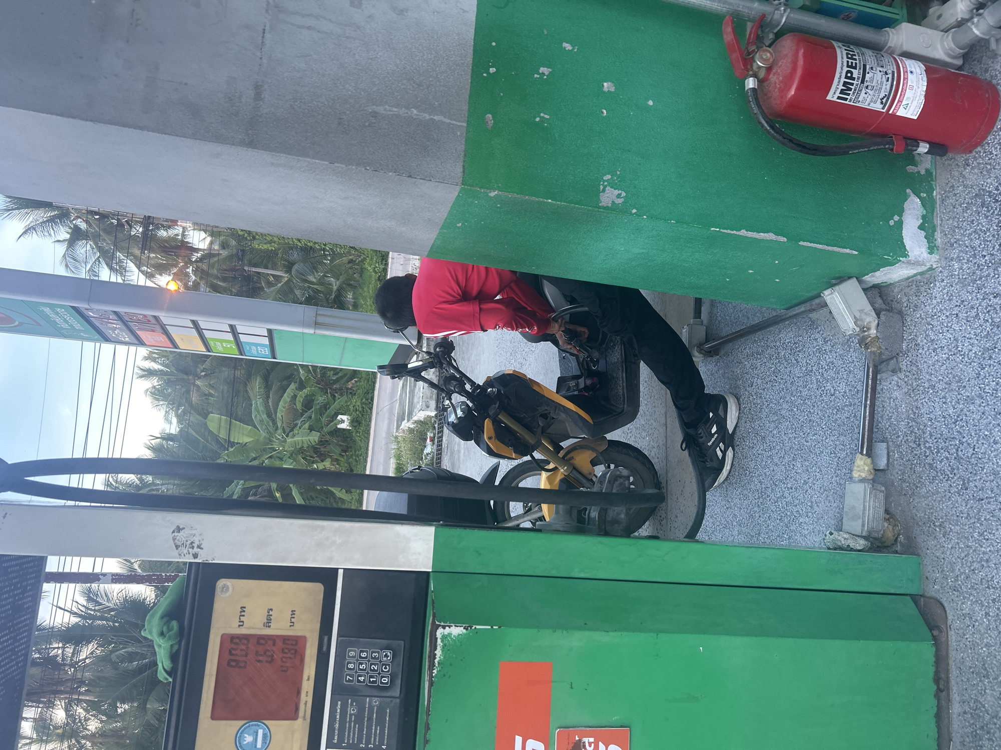 Person fills gas container at Koh Phangan station