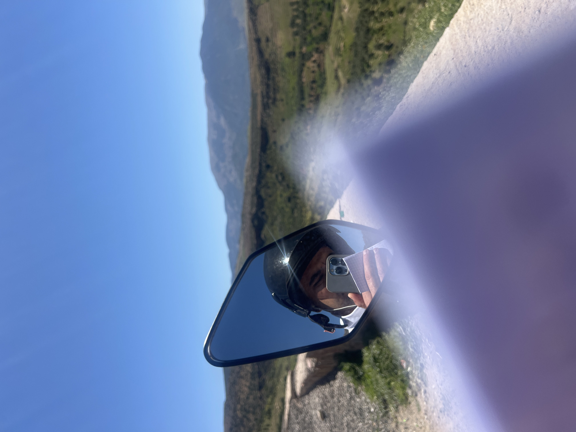 Motorcyclist captures selfie in mirror amid Morocco mountain landscape