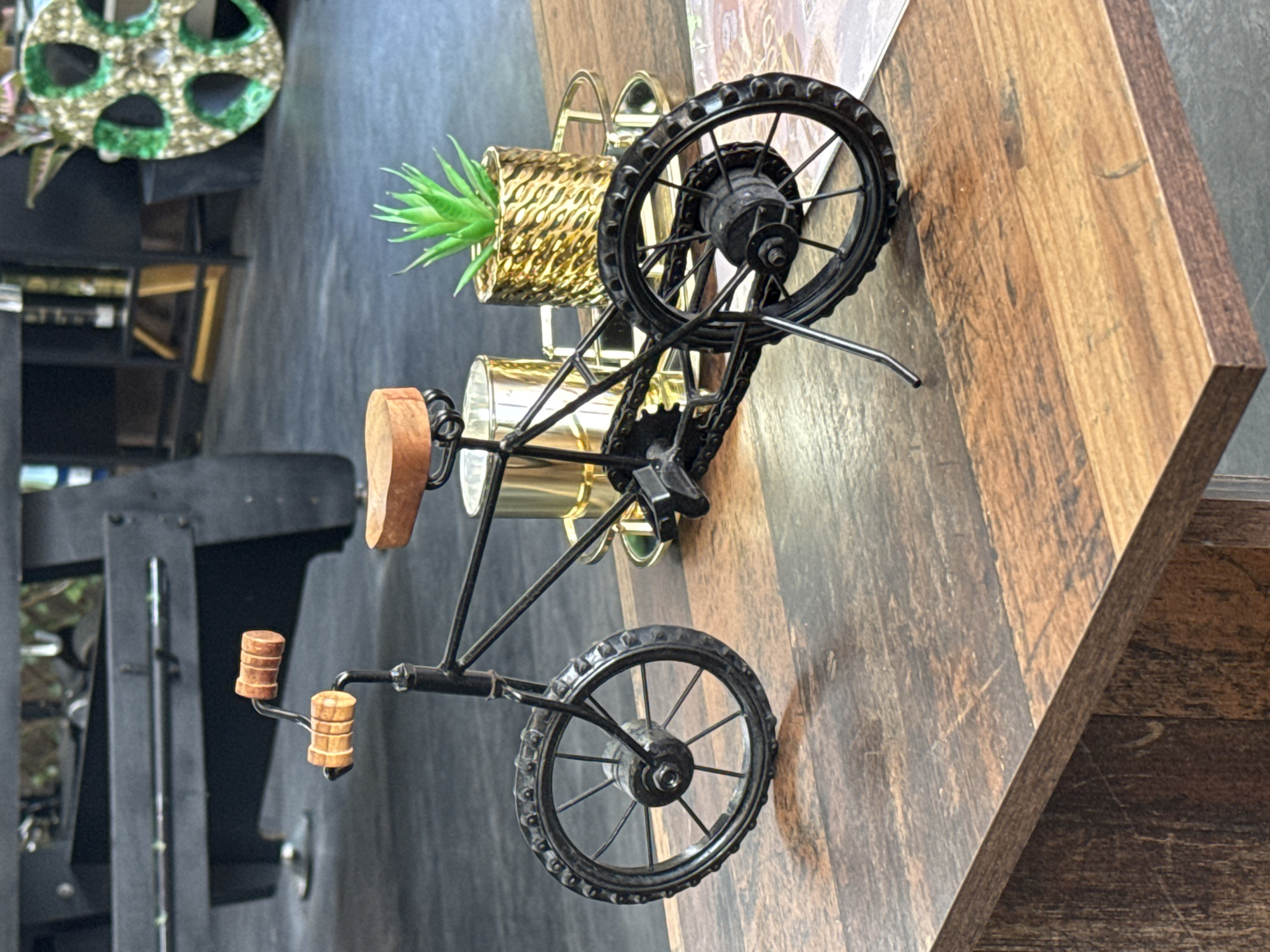 Miniature metal bicycle on a wooden table in Sankt Wendel