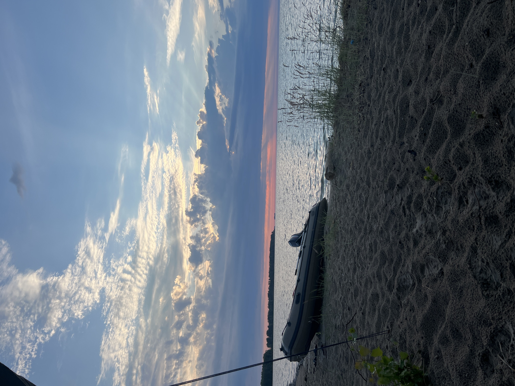 Inflatable boat on shore at dusk, Borovoe lakeside