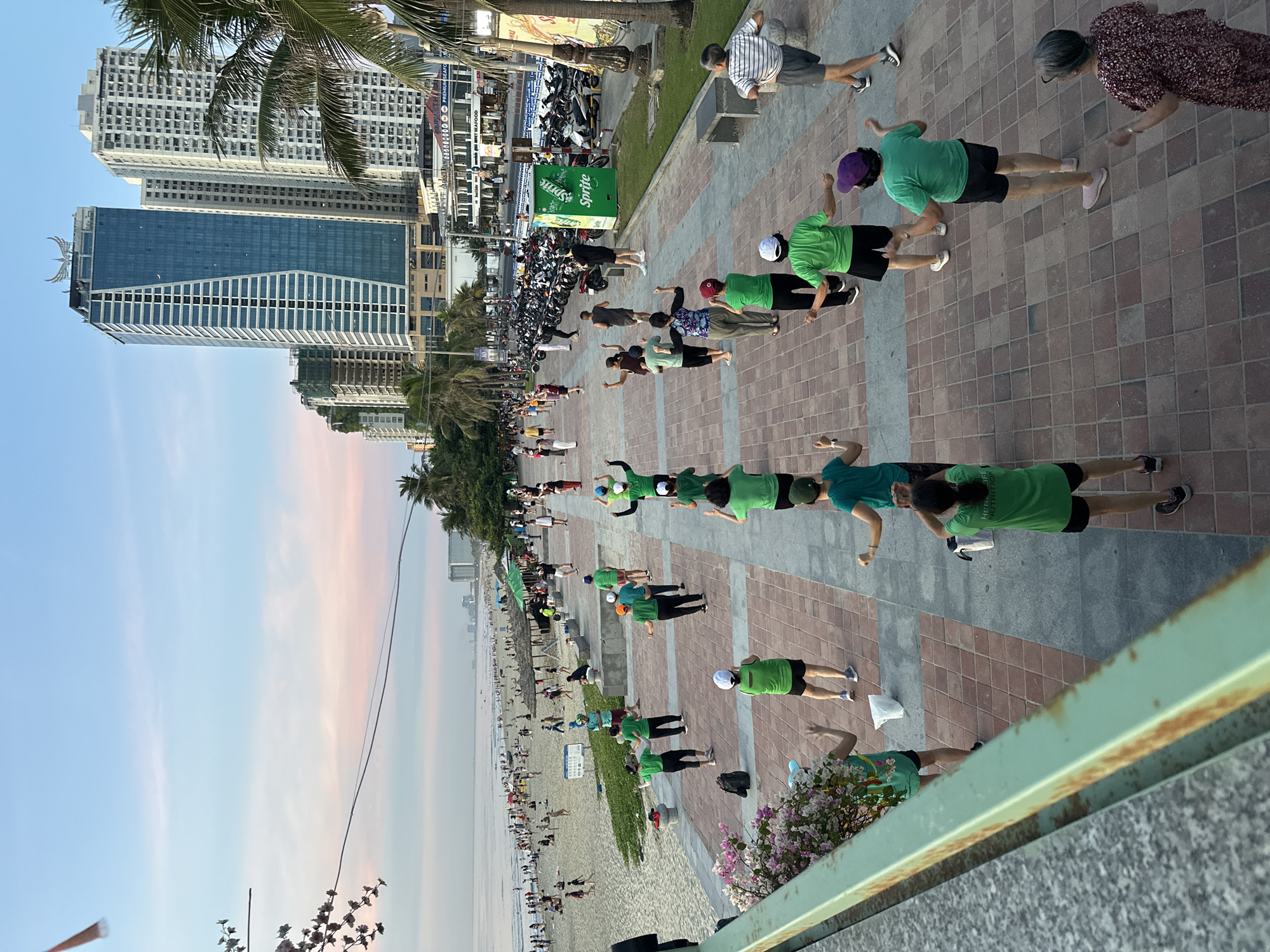 Mỹ Khê Beach at golden hour — crowds, exercise, and ocean views