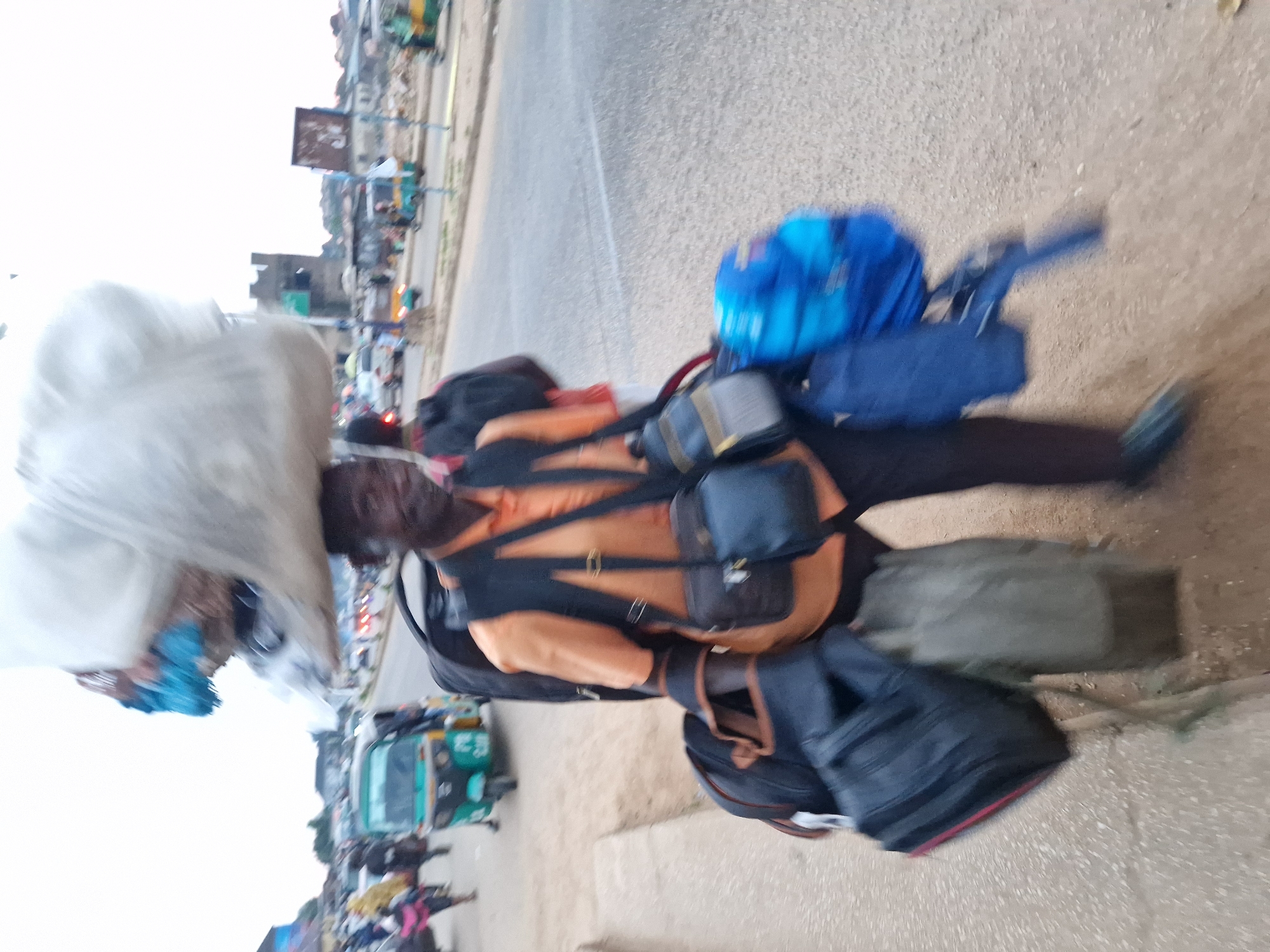 Foot traffic and daily life along a Jos street at dusk