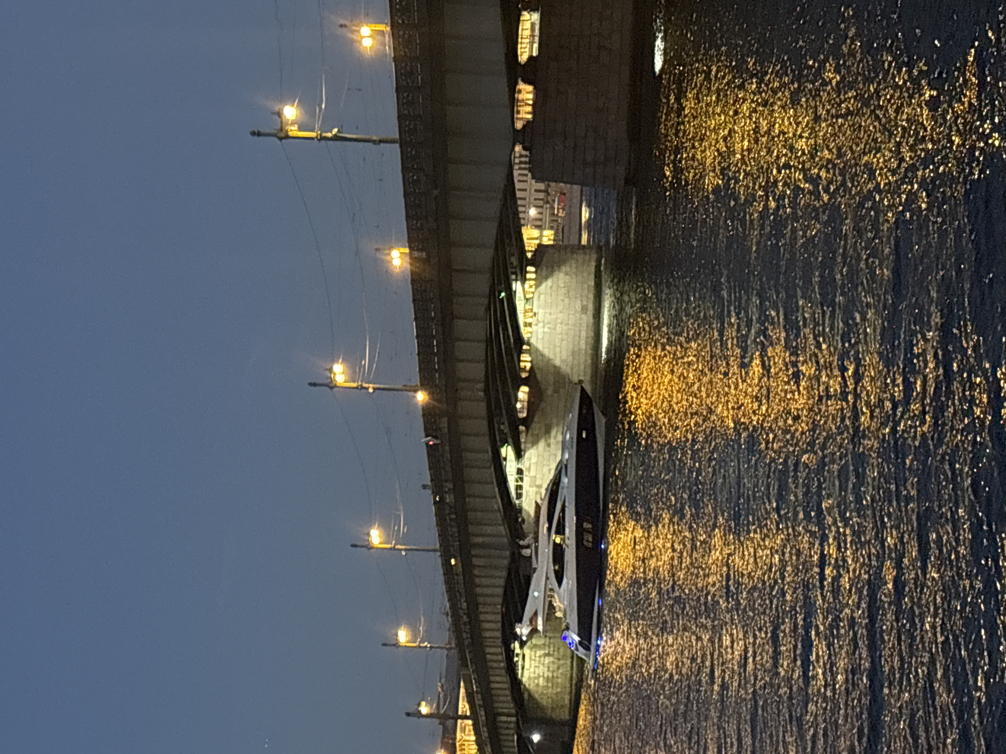 White yacht cruises the Neva River on a St. Petersburg summer night