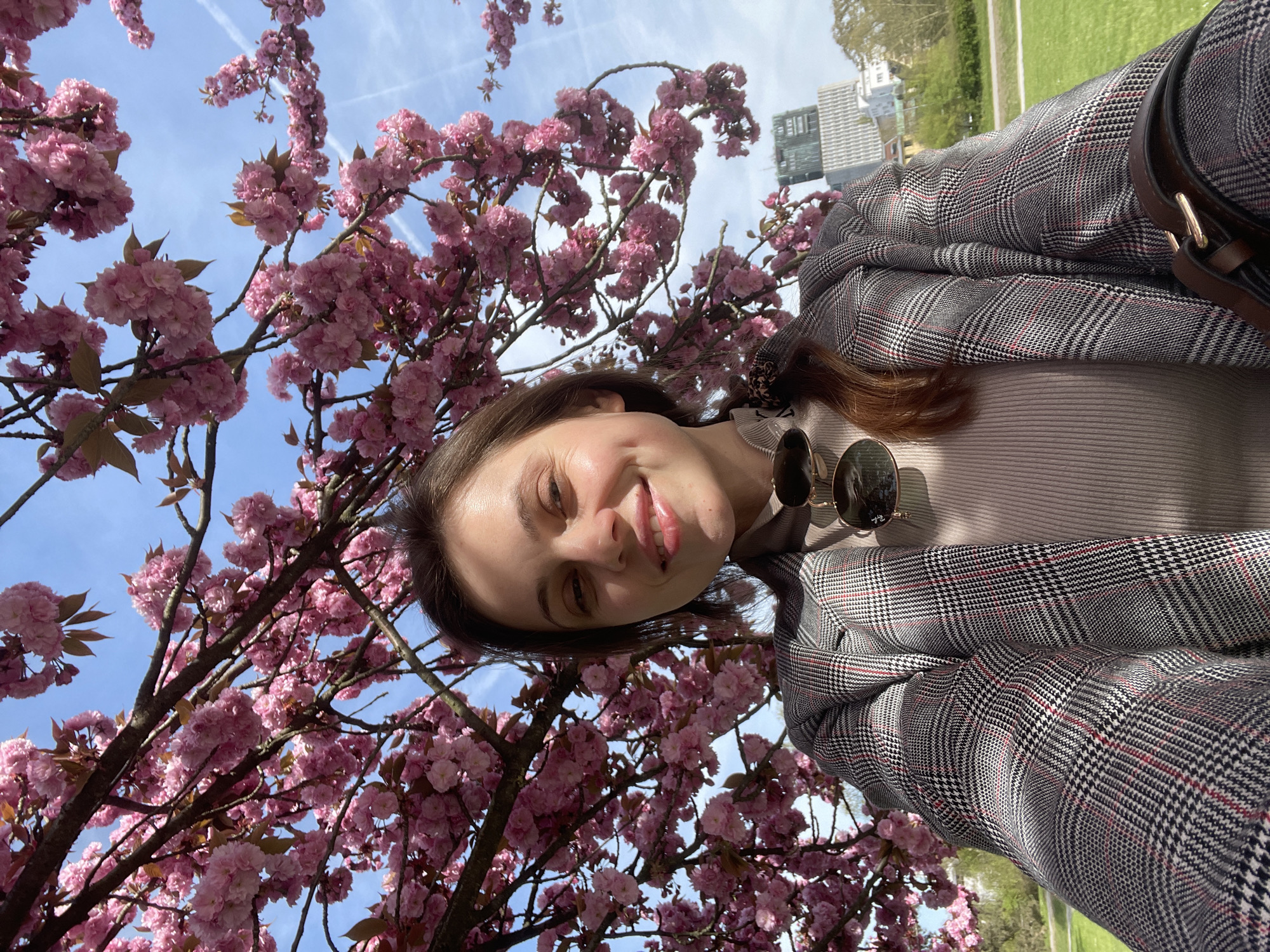 Woman takes selfies during spring afternoon in Ljubljana park