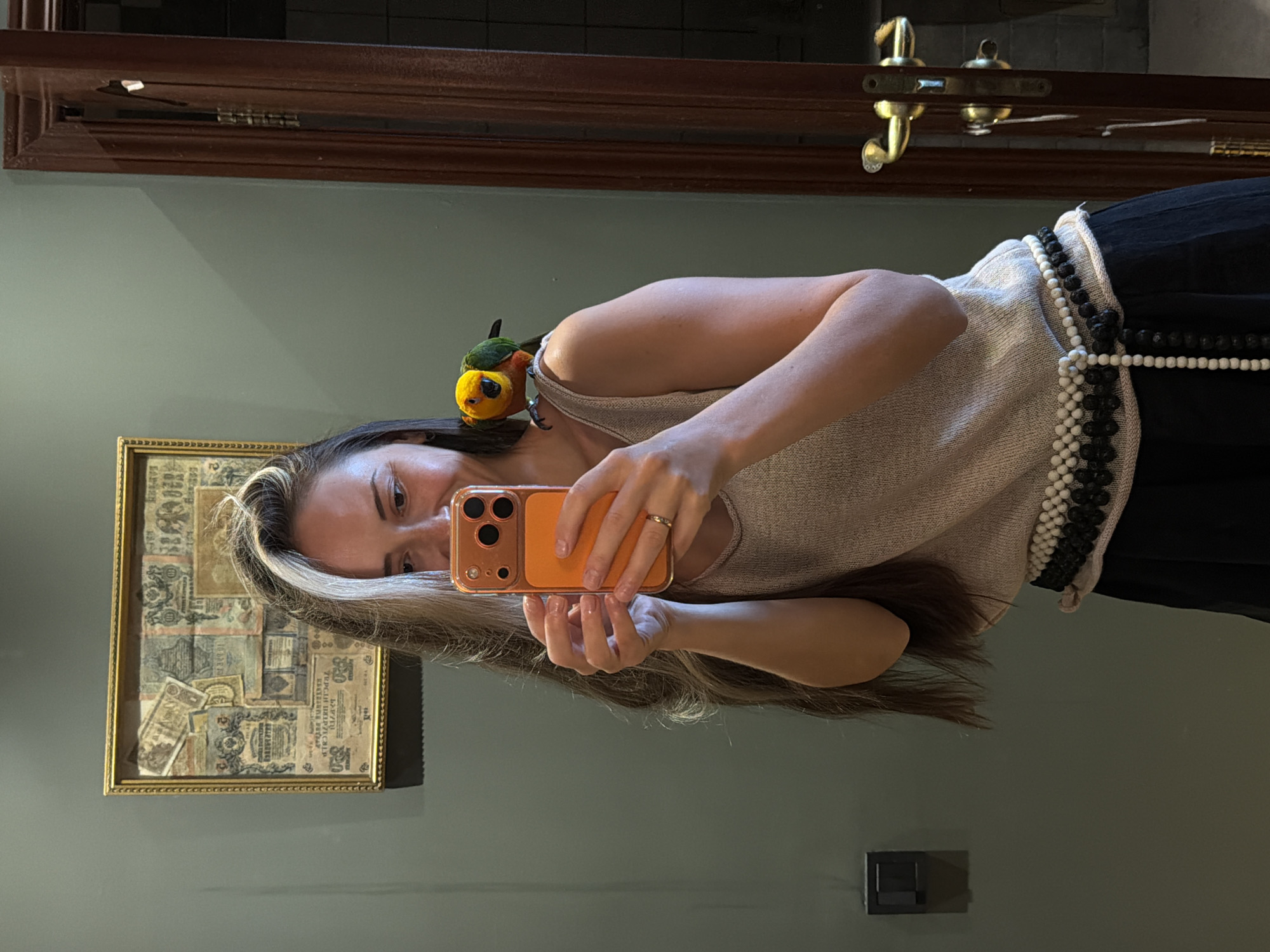 Woman and child share morning moments with pet parrot
