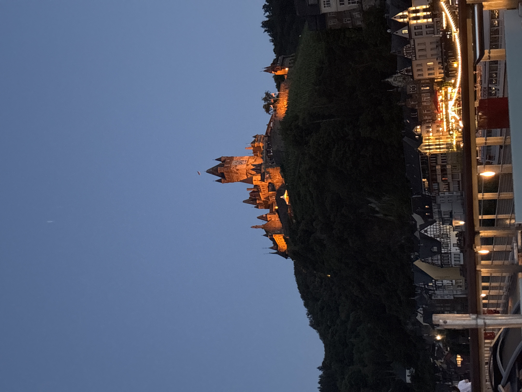 Reichsburg Castle glows over Cochem at dusk