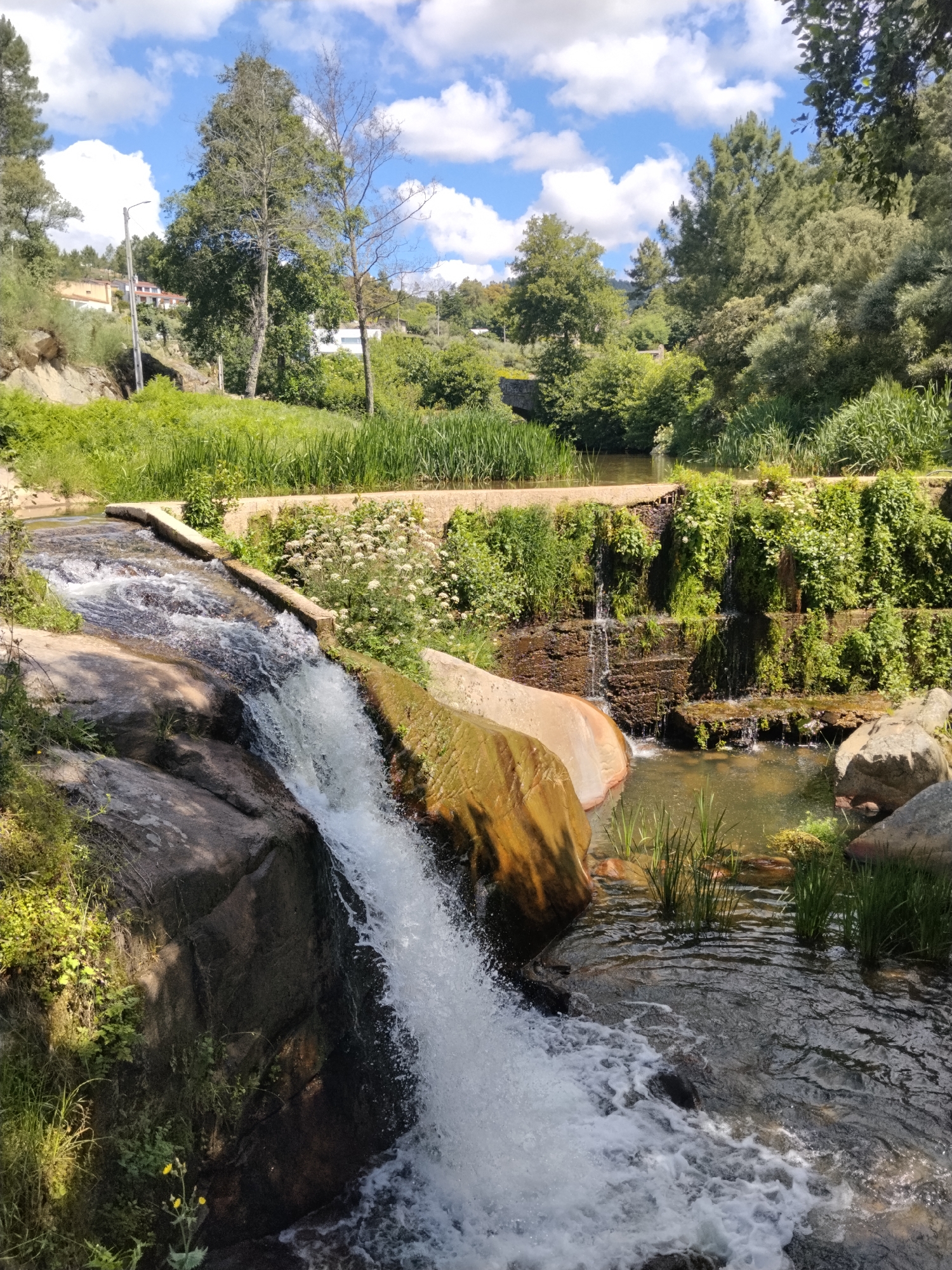 Visitor explores waterfall walkways and monument in Alijó, Portugal